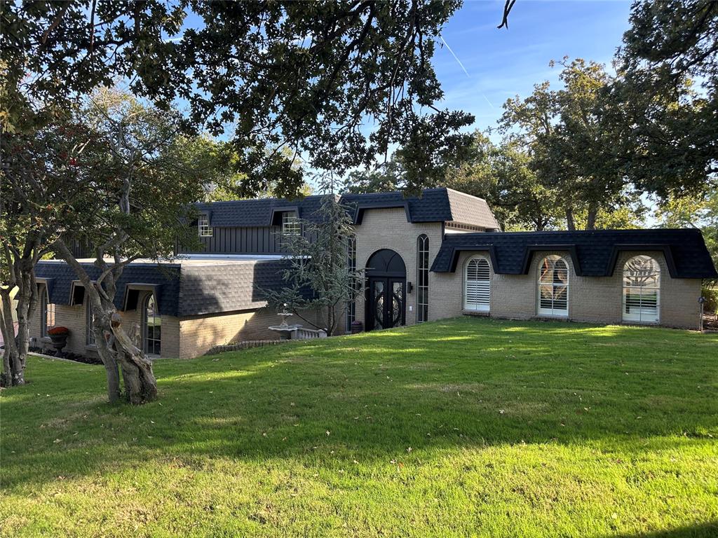 Beautifully remodeled tri-level home within walking distance to Lake Overholser!  Double wrought-iron doors, a dazzling chandelier, and a gorgeous winding stairwell greet you as you enter this amazing home. It feels elegant from the moment you enter the foyer.  On the first level, you'll find a wonderful living area with a fireplace, bookshelves, and a wet bar.  Double doors lead out to the amazing wooded back yard and an impressive salt water swimming pool.  A half bath is also on this level and comfortably accommodates your guests.  The primary bedroom and bath are stunning.  There are two closets, and large barn doors lead you to the sleek bathroom with double sinks, separate tub and shower, and the coolest 'light switch' that I've ever seen (vent/heater/light with multi-function switch)!  The bathrooms in this house truly feel like an expensive hotel!  The utility room and garage access are also on the first level.  The second level of this gorgeous home is another spacious living area with plantation shutters, lots of natural light, and an easy flow into the formal dining area with a picture window that looks out onto the back yard.  The kitchen is on this level and has easy access to every room in the house.  The kitchen has granite countertops, a double oven, and a cozy breakfast area that has four windows with plantation shutters opening to the back yard.  Plus a pantry that covers an entire wall of this breakfast area!
The third level of this stunning home has two beautiful bathrooms and three incredibly spacious bedrooms.  Extra storage spaces line the entire hallway leading to these bathrooms and bedrooms.  There are two new HVAC systems, a new Mansard roof, and a central vacuum system for the entire home.   The yard is picturesque, wooded, and very private.  There is an outbuilding and lots of concrete patio space for lots of entertaining or just peaceful, quiet times.  The driveway on the east side of the home is huge.  This home is just fabulous.
