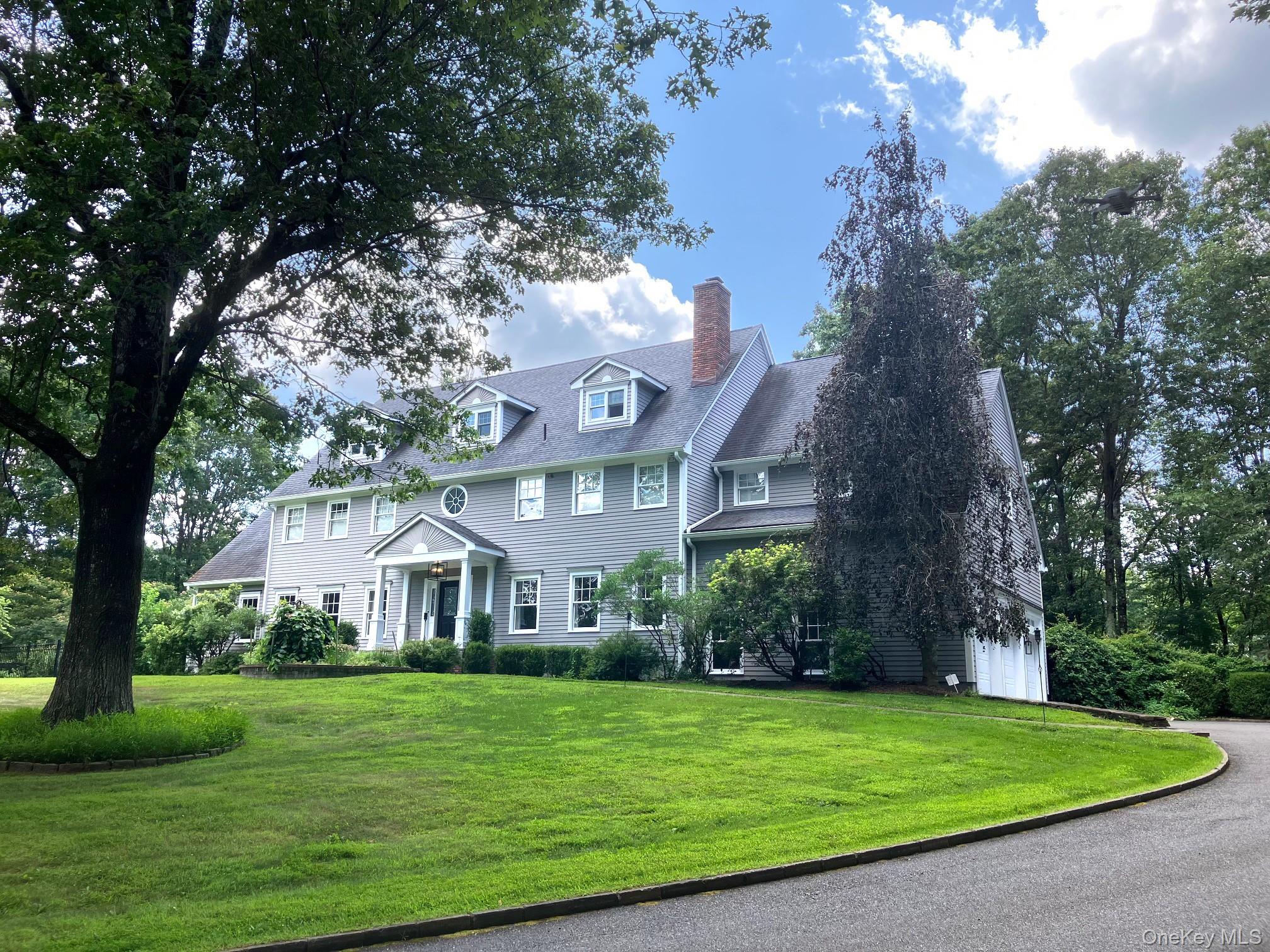 Move right into this timeless Country Colonial set on over two level, beautiful acres in sought-after Pound Ridge. Enjoy the heated pool, spa, and pool house surrounded by mature landscaping and private, open grounds.  This turnkey residence spans over 6,000 sq ft, with a welcoming two-story foyer, sun-filled formal living and dining rooms, and hardwood floors throughout. The spacious eat-in chef’s kitchen with marble countertops features an expansive island and sunny breakfast area, and opens to an inviting Great Room with a stone fireplace—ideal for everyday living and entertaining. A private home office creates a quiet workspace, while a screened porch and bluestone patio are perfect for relaxing outdoors.  Upstairs, the primary suite serves as a serene retreat with a sitting area, dual walk-in closets, and a spa-like bath, complemented by three additional en suite bedrooms. The finished lower level adds flexible space for recreation, fitness, and guests.  Additional features include solar panels, a whole-house generator, and a three-car garage. Minutes to shops, schools, trails, and dining. One hour to Manhattan.