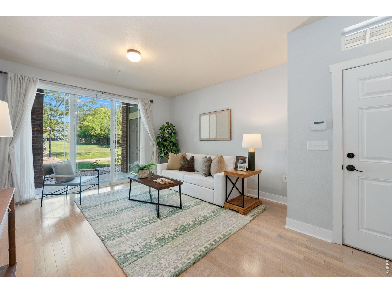 Discover comfort and convenience with this beautifully maintained ground-level condo near Jessup Farm. Perfectly situated as a desirable corner unit, this inviting two bedroom home offers enhanced privacy and direct connection to the neighboring green space and convenient covered parking. The interior features include extra wide hallways and spacious bathrooms, creating an open, airy feel with enhanced accessibility. The heart of the home is the welcoming living room, where a cozy gas fireplace sets the perfect ambiance for relaxing evenings or casual gatherings. A newly installed AC unit provides modern comfort year-round, while the home's excellent condition reflects true pride of ownership. With its desirable location, additional amenities like a community pool, and move-in-ready appeal, this condo offers the perfect blend of style, space, and low-maintenance living!