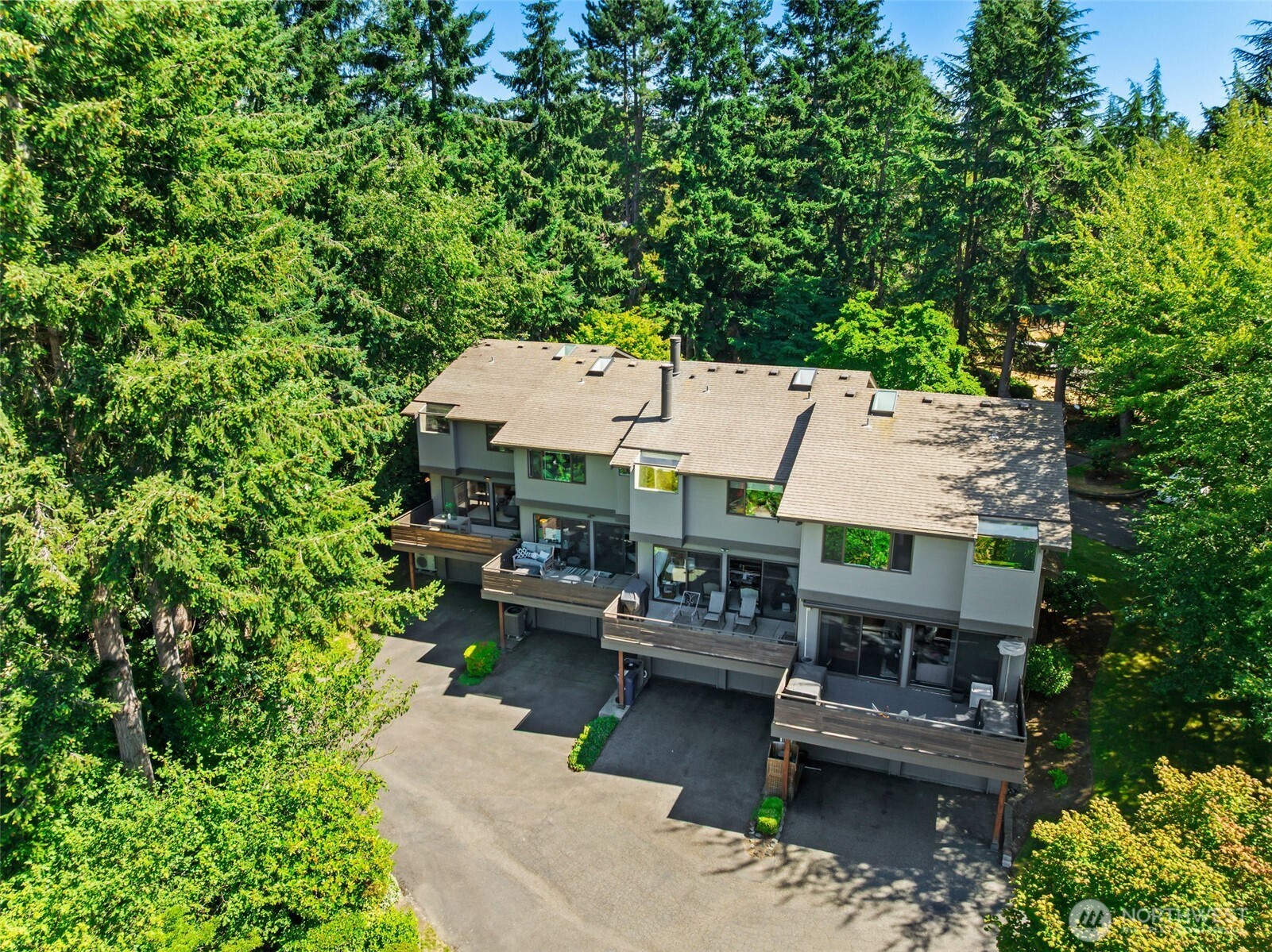 Attractive façade nestled among towering evergreens for exceptional privacy.