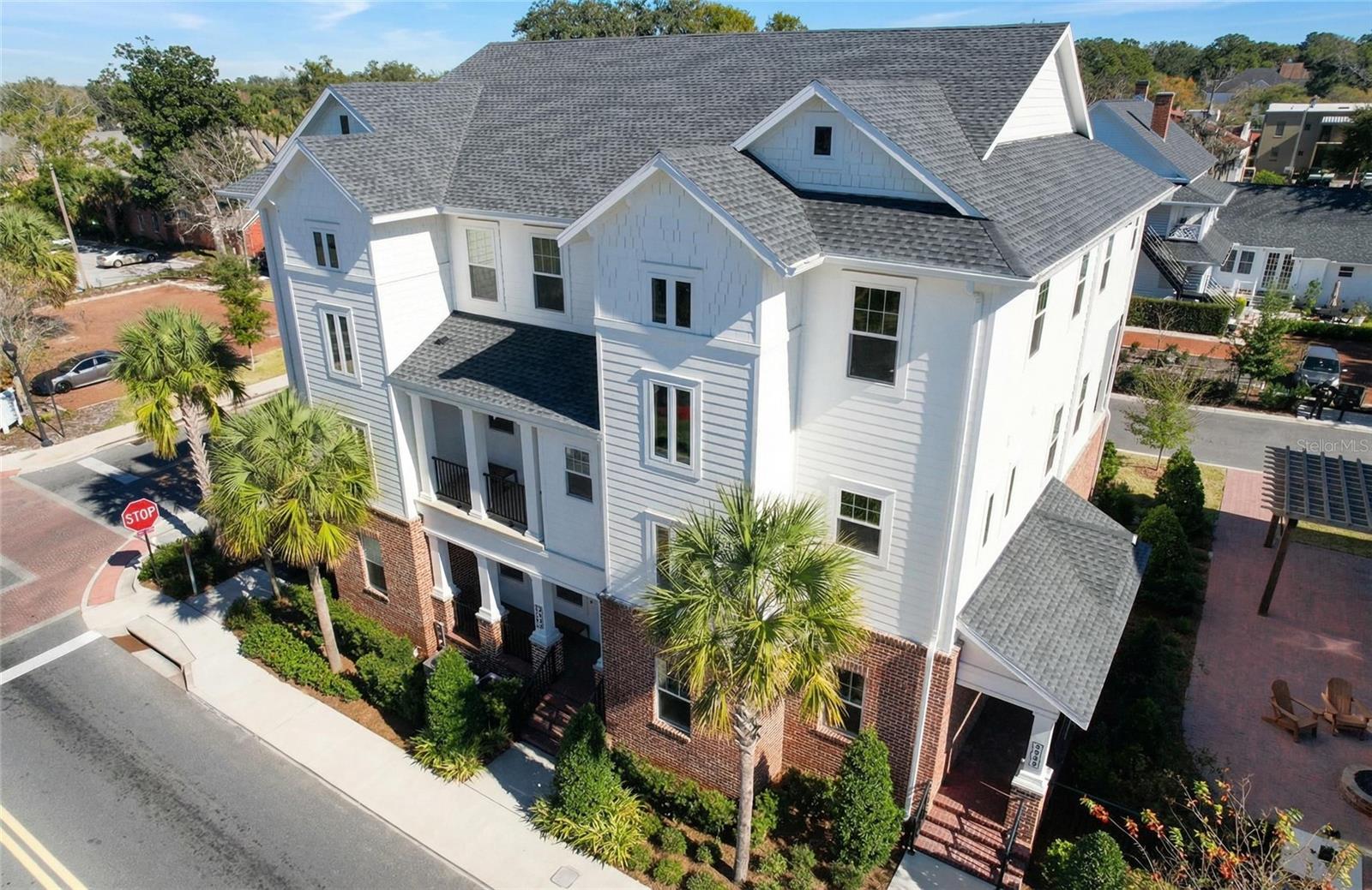 Experience refined downtown living in this beautifully designed three-story townhouse in the heart of Ocala. Offering 3 spacious bedrooms, 3 full bathrooms, and 1 half bath, every bedroom features its own private en suite—perfect for comfort and privacy. The first floor includes a versatile bedroom that makes an ideal home office, guest suite, or flex space. Upstairs on the second level, enjoy an open-concept layout with a bright and inviting living, dining, and kitchen area that flows seamlessly onto a private balcony—perfect for morning coffee or evening relaxation. This home is thoughtfully designed with convenience in mind, featuring two laundry closets—one on the ground floor and another on the top level. The third floor hosts a generous primary suite complete with a massive walk-in closet, creating a true retreat. Located in a gated community with a cozy firepit gathering area, this home offers both security and a sense of community. Situated directly across from City Hall and just steps from downtown Ocala’s shops, dining, and entertainment, you’ll enjoy the best of urban living right outside your door. Elevator option available for purchase!