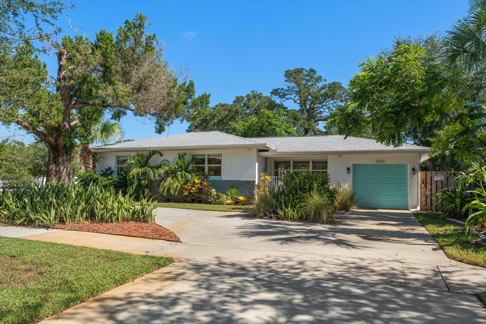 PRICED BELOW APPRAISED VALUE! Beautifully remodeled 3BR/2.5BA coastal modern oasis on a RARE, MASSIVE 82x150 lot in St. Petersburg's highly coveted South Shore Park! Spanning 1,521 sq ft of pristine turnkey design, this home features a clean modern aesthetic, a coveted spacious 1-car garage, and a relaxed coastal vibe. Cook up some fun in the refreshed kitchen—a fantastic entertainer's space boasting a large island and premium, upgraded granite countertops that spill across the room. Ideal for indoor-outdoor hosting, the thoughtful split floor plan allows family and friends plenty of room to spread out, with a dedicated indoor laundry room and extensive 2021 renovations that offer complete peace of mind with a 2021 roof and appliances. Step outside to your private outdoor entertaining paradise featuring an oversized, landscaped 12,300 sq ft lot built for weekend BBQs with a large back patio and premium Trex decking on both the front and back porches, and incredible potential to split the lot and sell off a parcel for development, or keep it whole to add a luxury pool and a private pickleball court! Location is an outdoor and foodie lover's dream: walk down the street to catch a waterfront sunrise at Lassing Park or use the kayak launch right at the end of the road. Public boat ramps and luscious local dining are less than 5 minutes away, and it's an easy 5-minute bike ride to vibrant Downtown St. Pete. Plus, enjoy easy access to the interstate for a seamless commute! Come home to the perfect quiet retreat, spacious paradise, and investment opportunity. Schedule your showing today!