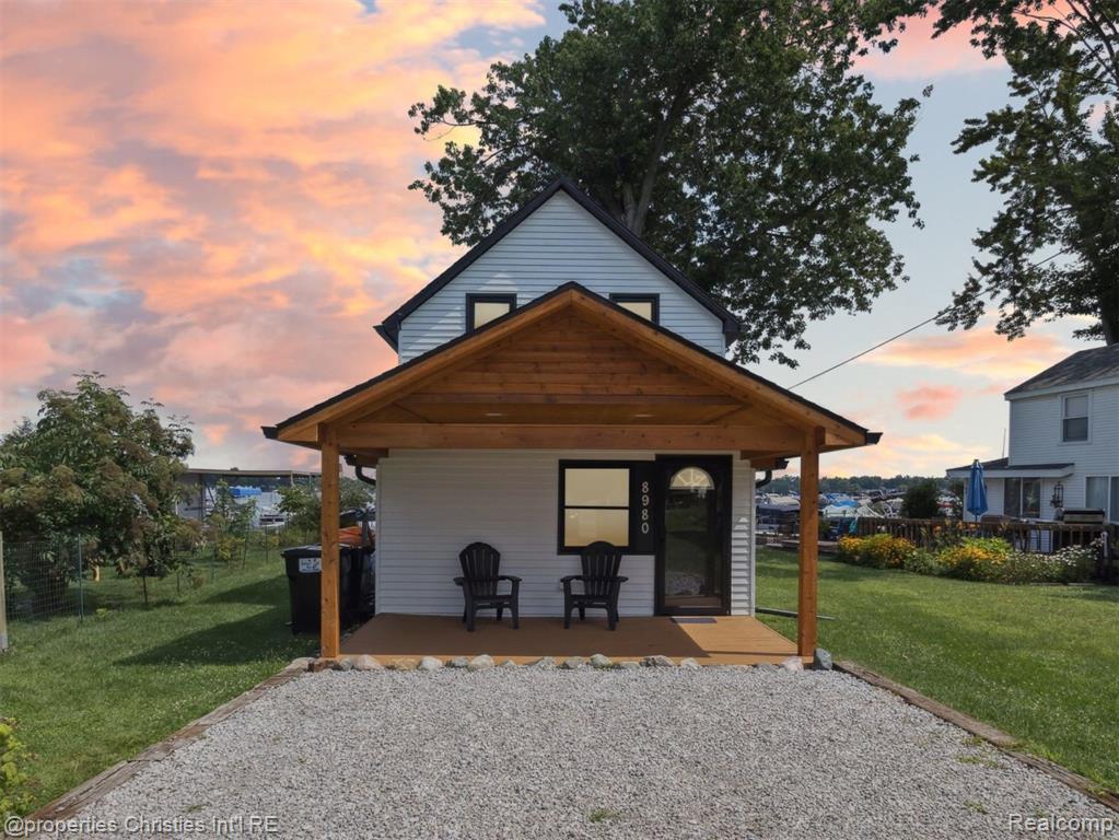 Welcome to this stunning, fully renovated lakefront retreat on the coveted all-sports Portage Lake, part of the Portage Chain of Lakes. Recently completed in 2025, this beautiful home blends modern updates with cozy cottage vibes, offering the perfect escape for year-round living or a weekend getaway. Step inside to an open-concept living space filled with natural light and thoughtfully designed for entertaining and relaxation. You’ll enjoy incredible views of the lake throughout every room! Head upstairs to find the bedrooms, full bathroom, and a spacious loft-style room to spread out and unwind. An additional full bathroom on the main level ensures comfort and accessibility for guests and everyday living. Enjoy a morning coffee or after-dinner cocktails on your choice of the covered front or rear porch, just steps from the water. Spend your evenings by the fire pit at the water’s edge, where gorgeous sunsets and peaceful moments await. Whether you're boating, kayaking, swimming, or simply soaking up lake life, this property puts it all within reach. Newer sea wall in 2023 with 42 feet of Pure Michigan water frontage. Mini split systems on both the main floor and upstairs provide efficient cooling throughout the summer. To top it off, the home comes fully furnished, so you can move right in and start making memories. Conveniently located with many nearby amenities, including the local boat launch, Riverside Pizza, NautiMI ice cream and coffee shop, and many other grocery and restaurant options. This is a rare, turnkey opportunity on one of Michigan’s most desirable lake chains. Don't miss your chance to make it yours!