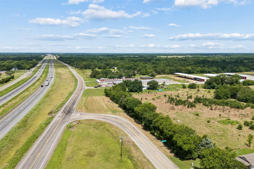 Rare opportunity to own 63 acres of versatile Texas land with exceptional visibility and access in one of Northeast Texas's fastest growing corridors. Strategically positioned off Interstate 30 with 450 feet of frontage on FM 499 and I-30, this property offers the kind of location investors and developers dream about with high traffic exposure. The tract features a beautiful mix of open pasture, scattered mature trees, and a stocked pond, making it as visually appealing as it is functional. Zero floodplain every acre is usable. Currently carrying an agricultural exemption, keeping your carrying costs low while you plan your next move. Whether you're looking to hold as a long-term investment, develop commercial or industrial uses capitalizing on the I-30 corridor traffic, or build your dream ranch-style retreat, this land checks every box. Utilities are available at the road, making future development straightforward. Neighboring storage facilities demonstrate the commercial viability of the area, and being outside city limits offers flexibility with fewer restrictions.