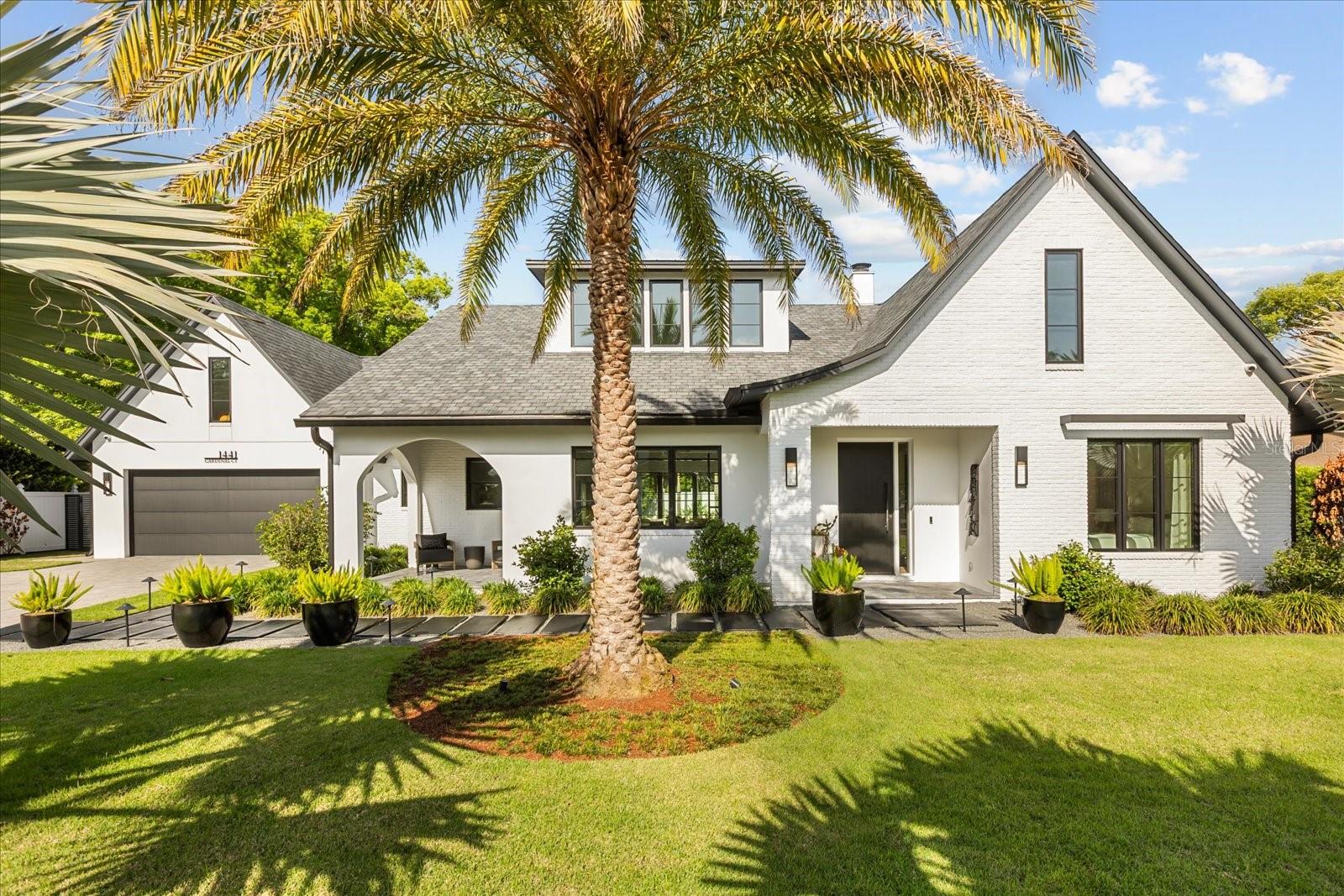 Beautifully built in 2022 by Lonnie Richardson, this custom one-story home sits on a quiet cul-de-sac in the heart of Winter Park. Designed with a modern, timeless style, it offers luxury finishes paired with a warm, comfortable feel.The home features 4,060 square feet, including four en-suite bedrooms, five full bathrooms, a powder bath, and a bonus room with a built-in office. The spacious gourmet kitchen overlooks the main living areas and pool, and is equipped with premium Wolf appliances and a separate chef’s kitchen for added convenience.Enjoy seamless indoor-outdoor living with a covered lanai featuring motorized screens, heaters, and a mosquito misting system. The outdoor space also includes a summer kitchen, gas fire pit, and a pool equipped with a swim jet system that creates a continuous current, effectively transforming it into an endless lap pool.A detached fitness studio with a steam shower provides a private wellness retreat. Additional highlights include custom built-ins, engineered hardwood floors and surround sound throughout.The oversized two-car garage offers epoxy flooring, custom storage, and a dog wash station. Irrigation is supplied by a private well, and the home also features underground utilities and a full security system.The exterior is designed for both beauty and low maintenance, with manicured landscaping and artificial turf that stays lush year-round. With no HOA, added privacy, and exceptional attention to detail throughout, this home offers a rare opportunity to experience luxury living at its finest.This home is conveniently located near the Enzian Theater and less than a mile from Winter Park Village, with top-rated schools nearby, this home combines comfort, style and an unbeatable location.Schedule your private showing today.