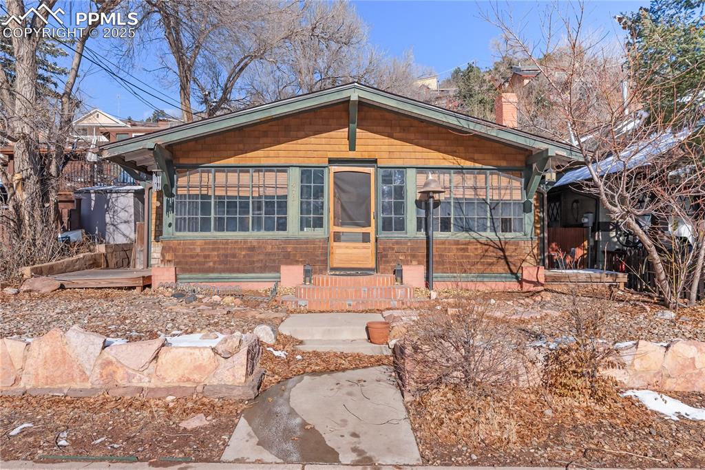 This charming fixer upper is full of potential and ready for your vision! Located close to beautiful parks, within walking distance to vibrant Manitou Avenue, and just minutes from Highway 24 for an easy commute, this home offers both opportunity and convenience.With most of the home being original to 1919, there is 2 bedrooms and 2 bathrooms, plus an additional bonus room perfect for a home office, studio, or creative flex space. The living area is anchored by a cozy wood-burning fireplace, adding warmth and character. At the front of the house, you’ll love the gorgeous sunroom, filled with natural light—an ideal spot for morning coffee or simply enjoying the mountain views. If you look closely, you can even see some of the original glass panels when the home was built! Located in the front yard is a mature peach tree for your enjoyment. With its fantastic location, functional layout, and abundant charm, this home offers a rare chance to create something truly special in the heart of Manitou Springs. Whether you're an investor or a homeowner with a vision, this property is ready to be transformed!
