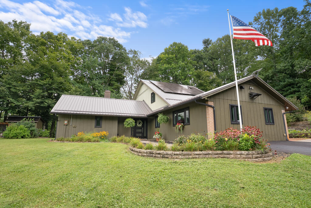 Privacy, space, and convenience come together in this beautiful 5-bedroom, 3.5-bath home set on 3.9 acres. This well-appointed property offers two master bedroom and bath suites, including a spacious primary suite with a huge closet, providing excellent flexibility for family, guests, or multigenerational living. The kitchen features granite countertops, stainless steel appliances, and a convenient pantry, while the large family dining area provides plenty of space for gatherings and entertaining. Interior updates include new windows, new flooring, updated bathrooms, a combination of LVP and wood floors, and thoughtful conveniences such as a laundry chute, linen closet, and spacious laundry room/mudroom. Step outside to the screened-in porch with ceiling fan and relax while listening to the soothing sounds of the koi pond and enjoying the peaceful surroundings. A small creek flows through the property, adding to its peaceful setting and natural charm. The outdoor amenities continue with a firepit, blueberry bushes, pear tree, koi pond, and a small fenced dog area. For the hobbyist or those needing additional workspace, the property offers a 30 x 35 metal garage with pellet stove and 200-amp service, a 16 x 36 utility shed, and an 8 x 10 chicken hut equipped with water and electricity. Additional features include solar panels and a LeafGuard gutter system. With its private setting, abundant storage, multiple living options, and convenient location between Hillsville and Galax, this property offers the opportunity to enjoy peaceful country living with plenty of room to live, work, and relax.