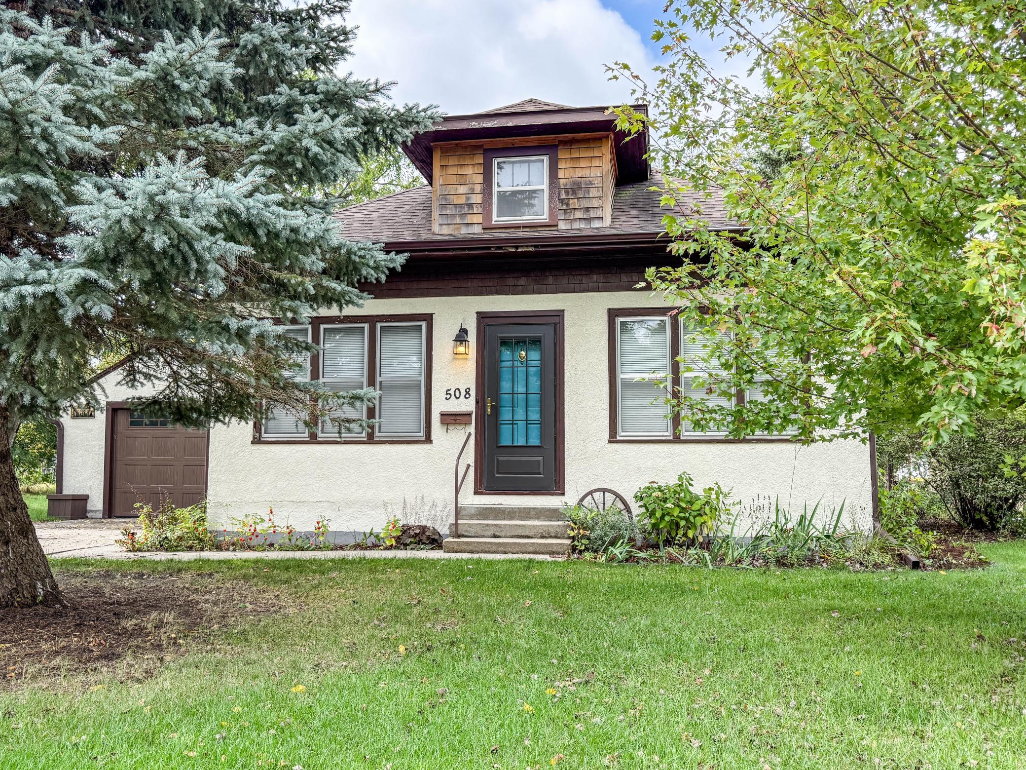 Welcome home to 508 Belmont Street, a charming 3-bedroom (plus a non-conforming 4th bedroom), 2-bathroom property on a 0.25-acre lot in the center Paynesville, MN. Step inside to a sun-filled 3- season front porch, as you proceed to enter you will notice the beauty of the original character with the wooden built -ins, the high ceilings throughout, and the details in the windows that meet the modernized kitchen, fully equipped with stainless steel appliances. Additional main floor features are a dining room, living room, a newly renovated bathroom complete with a crisp white subway tile surround, two main floor bedrooms, and a versatile den with peaceful views of the outdoor oasis.  The finished lower level expands your living space with a second family room area centered by a cozy fireplace. A 3/4 bathroom, dedicated laundry/utility room, bedroom with an egress window, and an additional non-conforming bedroom complete the layout.  The true highlight of this property is its backyard—officially certified as a Backyard Wildlife Habitat by the National Wildlife Federation. Unwind or entertain guests on the expansive back deck featuring a sunken hot tub.  This home sits just minutes from local Paynesville amenities, including the scenic shores and boat launches of Lake Koronis, the Lake Koronis Recreational Trail, local parks, golf course, schools, hospital & healthcare facilities, grocery store, restaurants, and charming downtown shops.