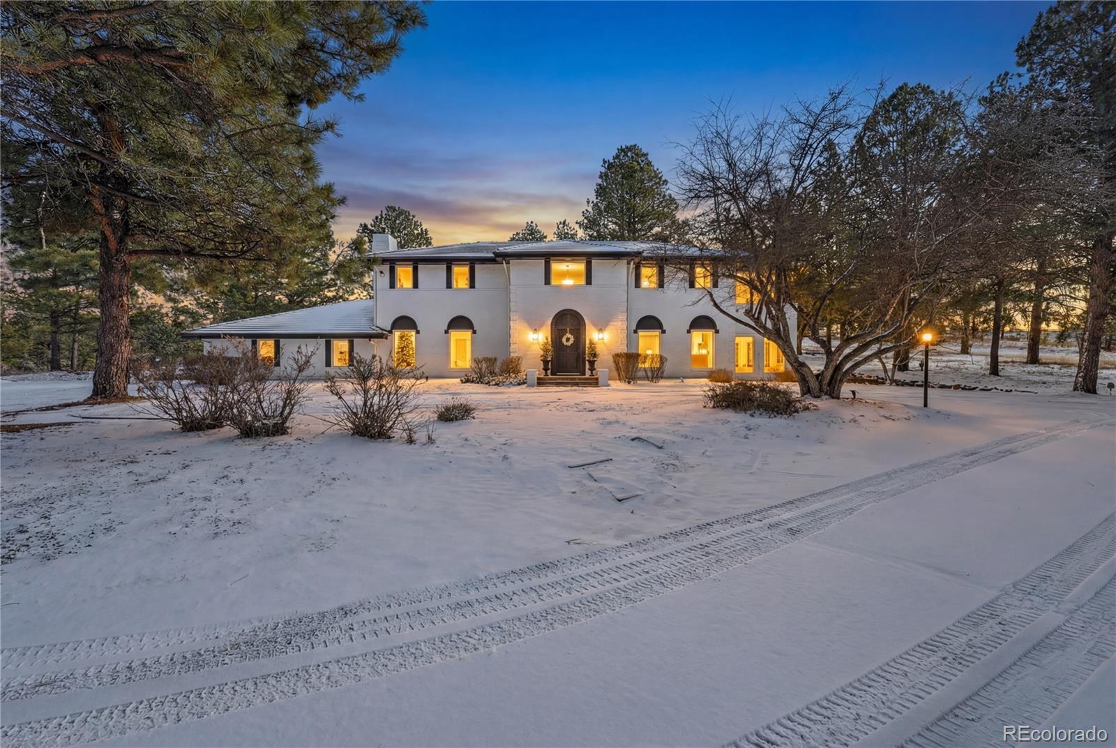 Don't miss this coveted custom brick home on 5 acres surrounded by tall trees, private ravines to the west & north with 85 acres of space to the east and south, at the end of the cul-de-sac, located in Parker, Colorado adjoining the Colorado Golf Club. This home has been completely remodeled including new Pella windows and doors. Timeless elegance abounds from the entry foyer and balcony to the formal living, dining and office, each with their own cozy fireplace. The kitchen boasts an oversized island with plenty of cabinets and a large walk-in pantry. The basement has a private entrance with an expansive family room, temperature controlled oversized wine cellar and a generous workout room, including an infrared sauna. Beautifully landscaped with a paved driveway, flagstone walkways, lighting, and multiple patios. The home has two cedar deck areas: an attached oversized deck in the backyard has a gas outdoor fire pit. The large deck on the north side of the house includes an oversized 17ft swim spa. An irrigated greenhouse makes for a great covered garden. Includes a 3 car attached garage with a circle driveway for plenty of outdoor parking.