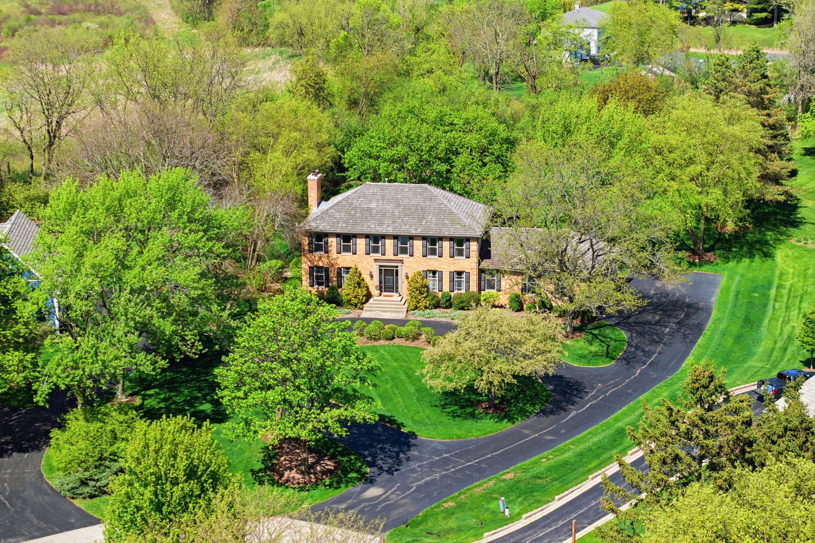 Nestled at the end of a quiet cul-de-sac in the desirable Deer Lake Meadows community, this exceptional brick residence offers a rare combination of sophistication, warmth, and serene natural surroundings with picturesque forest preserve views. A circular driveway, lush mature landscaping and striking updated front entry create beautiful curb appeal and an inviting arrival experience. Inside, you're welcomed by a spacious layout designed for both everyday living and entertaining. Wide plank hardwood flooring extends throughout the main level, while walls of windows fill the home with natural light. The expansive living and dining room combination offers an elegant yet comfortable gathering space featuring a fireplace, custom beadboard ceiling, and a stunning built-in bar complete with a nugget ice maker-perfect for hosting family and friends.  The beautifully updated kitchen is truly the heart of the home, showcasing quartz countertops, stainless steel appliances, double ovens, cooktop, wine refrigerator, updated lighting, and an abundance of cabinetry offering exceptional storage and functionality. The oversized island with seating for four creates the perfect space for casual dining, entertaining, or gathering during everyday living, while the spacious sun-filled eating area overlooks the backyard. Just off the kitchen, the adjacent office/flex room provides endless possibilities for a home office, playroom, sitting area, or additional entertaining space. A functional mudroom with built-in cubbies, generous storage, and a huge walk-in pantry adds even more convenience, along with a spacious laundry room featuring additional cabinetry and exterior access. Upstairs, the primary suite serves as a relaxing retreat with soaring ceilings, a walk-in closet, and a private bath featuring a spa tub and separate shower. Three additional generously sized bedrooms and an updated hall bath with dual sinks complete the second level. The finished walk-out basement lives like an entire second level of the home, offering incredible versatility and endless possibilities. Whether you envision the perfect recreation space, media room, game area, home gym, private office, hobby space, or even a 5th bedroom setup, this lower level can accommodate it all. Complete with a fireplace, built-ins, full bathroom, multiple storage rooms, and expansive open living areas, the space is ideal for entertaining or multi-generational living. Step directly outside to your private stone paver patio and enjoy the peaceful setting of the oversized backyard surrounded by mature trees and scenic forest preserve views, creating an unmatched sense of privacy and tranquility. Outdoor living is equally impressive with a spacious two-tier Trex deck offering multiple areas for dining, entertaining, relaxing, or enjoying evenings around a fire pit while overlooking the beautifully landscaped yard. Additional improvements completed in 2018 and 2019 include updated light fixtures throughout the main level, new furnace and humidifier, chimney repairs and cap, basement carpet and paint, new sump pump, exterior paint, and more. Located within the highly acclaimed Barrington School District and just minutes from shopping, dining, parks, and transportation, this exceptional home delivers timeless style in an unbeatable setting.