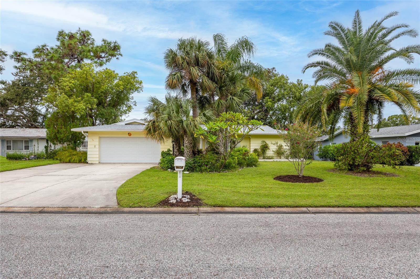 Welcome to this home filled with amazing potential, located in Fairway Estates, one of Dunedin’s most sought-after golf cart approved neighborhoods. This spacious 4-bedroom, 2-bathroom residence offers a desirable split bedroom floor plan that ensures privacy for the primary suite while maintaining a natural flow throughout the living spaces.
The home features both a formal living room and a more casual family room, creating flexibility for entertaining, relaxing, or setting up a home office. The kitchen is open to the family room and includes a convenient pass-through window to the lanai, making gatherings easy and enjoyable. The large 200 square foot covered and enclosed lanai, while not currently included in the 1,753 heated and cooled square footage, could easily be converted to additional air-conditioned living area, significantly expanding the footprint of the home and its value.
The primary suite includes its own ensuite bathroom for convenience and comfort, while the additional three bedrooms and full bath offer plenty of room for family or guests. Beautiful wood flooring runs throughout the main living areas and the primary bedroom, adding warmth and charm. The secondary bedrooms feature classic terrazzo floors and tile, with the terrazzo ready to be refinished to restore its mid-century modern appeal.
Major updates provide peace of mind, including a roof replaced in 2023, HVAC system in 2024, water heater in 2019, and updated windows installed between 2011 and 2013. The property is located in Flood Zone X where lenders do not require flood insurance and a Non-Evacuation zone, giving homeowners the benefit of reduced insurance concerns and security during storm season.   Fairway Estates has an active but VOLUNTARY/Optional Civic Association ($65 for the entire year) and NO DEED Restrictions!    It is a great active/social community to live in!
This home is all about location as much as it is about opportunity. Dunedin is known for its small-town charm with big lifestyle benefits. Just minutes away you’ll find the recently restored Donald Ross-designed Dunedin Golf Club, Honeymoon Island and Caladesi Island State Parks, and the miles-long Pinellas Trail. Nearby Highlander and Hammock Parks offer beautiful green space, while Dunedin Community and Fine Arts Centers provide endless activities and cultural experiences. Best of all, you are just a short golf cart ride to Delightful Downtown Dunedin with its vibrant mix of shops, restaurants, breweries, and festivals.
With its solid foundation, recent system updates, and unmatched location, this property is the perfect opportunity to create your dream home while enjoying everything that makes Dunedin such a special place to live.