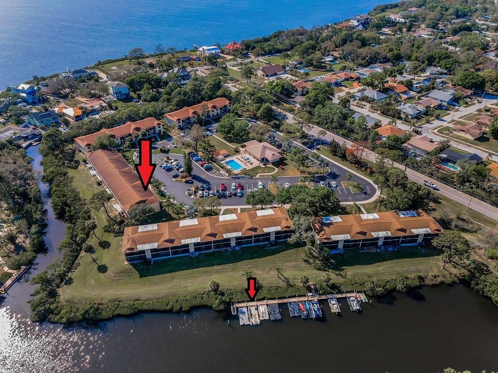 Rare Opportunity! Beautifully updated and move-in ready, this exceptional first-floor waterfront condo includes one of only 14 deeded boat slips (#9) with direct Gulf access. It also features one of only seven grandfathered waterfront decks (2022), the perfect place to relax, entertain, watch wildlife, or simply enjoy the peaceful canal views. Adding to its appeal is the remarkably low HOA fee of just $555 per month, covering virtually everything except electricity and making this an outstanding value for waterfront living.Deeded Boat Slip #9 features a versatile modular floating dock system, currently configured for a jet ski and kayak, along with a large weather-resistant storage box for your boating essentials. Located within the private, gated community dock, access is reserved exclusively for the 14 deeded boat slip owners, providing convenient Gulf access for boating, kayaking, fishing, and exploring Florida's beautiful waterways.Inside, you'll find a desirable split-bedroom floor plan with two bedrooms, two bathrooms, a separate laundry room, and quality finishes throughout. The beautifully remodeled kitchen showcases quartz countertops, custom ceiling-height cabinetry, a breakfast bar, pantry closet, and all new stainless-steel appliances (2023), including an induction range with convection oven, built-in microwave, refrigerator, dishwasher, and a water purification system. Just off the foyer are two additional built-in closets a pantry and a coat closet.The owner's suite overlooks the canal and features a large walk-in closet plus an ensuite bath with quartz countertops, a step-in shower, and a private water closet. The versatile guest bedroom is currently used as a home office and features a convenient Murphy bed, allowing the space to easily convert into a comfortable guest room whenever family and friends come to visit. The guest bathroom also features quartz countertops and a tub/shower combination.Hurricane-impact windows and sliding glass doors provide peace of mind, energy efficiency, and storm protection. The Condo is elevated and is in a Flood Zone X.The enclosed lanai, renovated in 2026, extends from the living room to the owner's suite, creating a comfortable year-round retreat with beautiful canal views. Luxury vinyl plank flooring throughout and porcelain tile in the lanai provide both style and durability.Additional updates include a water heater (2023), HVAC (2018), ceiling fans throughout, and a laundry room with a full-size washer, dryer, and extra storage. The furnishings, kayak, and fishing equipment are optionally included with an acceptable offer.This friendly waterfront community of just 68 residences offers a heated and chilled swimming pool, clubhouse with a full kitchen, fitness room, library, kayak storage, and bike storage.The $555 monthly HOA fee includes water, sewer, trash, cable, internet, landscaping, exterior maintenance, roof repair and replacement, building insurance and reserve funds. Ideally located just minutes from Sunset Beach, Fred Howard Park, the Pinellas Trail, the world-famous Tarpon Springs Sponge Docks, shopping, dining, golf, medical facilities, and highly rated schools.Not a 55+ community.