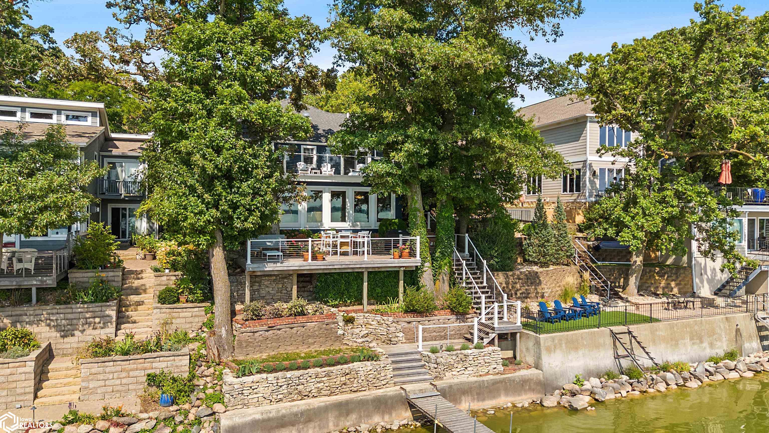 Gorgeous Lakeshore Living! Welcome to your dream retreat on the water. This beautifully designed lakeshore home blends luxury, comfort, and year-round recreation. Multiple living and family rooms give everyone space to relax, while the custom kitchen — featuring Jenn-Air appliances, a built-in wine fridge, and generous prep space — makes entertaining effortless. The newly designed lake room with panoramic windows opens to a maintenance-free deck perfect for cookouts, morning coffee, or sunset gatherings.  With 7 bedrooms and 4 bathrooms, this oversized home offers true main-floor living plus plenty of room for guests or large family get-togethers. The tree-lined shoreline creates a shady, private retreat from the bustle of North Shore, yet you’re just steps from the golf course and only a short walk from downtown.  Outdoor enthusiasts will love boating, fishing, paddleboarding, kayaking, and swimming right from your own backyard. In winter, enjoy ice fishing, snowshoeing, or cross-country skiing on the lake. After a day of activities, unwind on the deck or in the spacious lake room while soaking up endless views.  Two large attached garages provide abundant space for cars, boats, ATVs, and all your lake toys, while the unfinished basement offers generous storage space with potential for future customization.  Come see the custom finishes, abundant natural light, and thoughtful design for yourself—this is lakeshore living at its best!