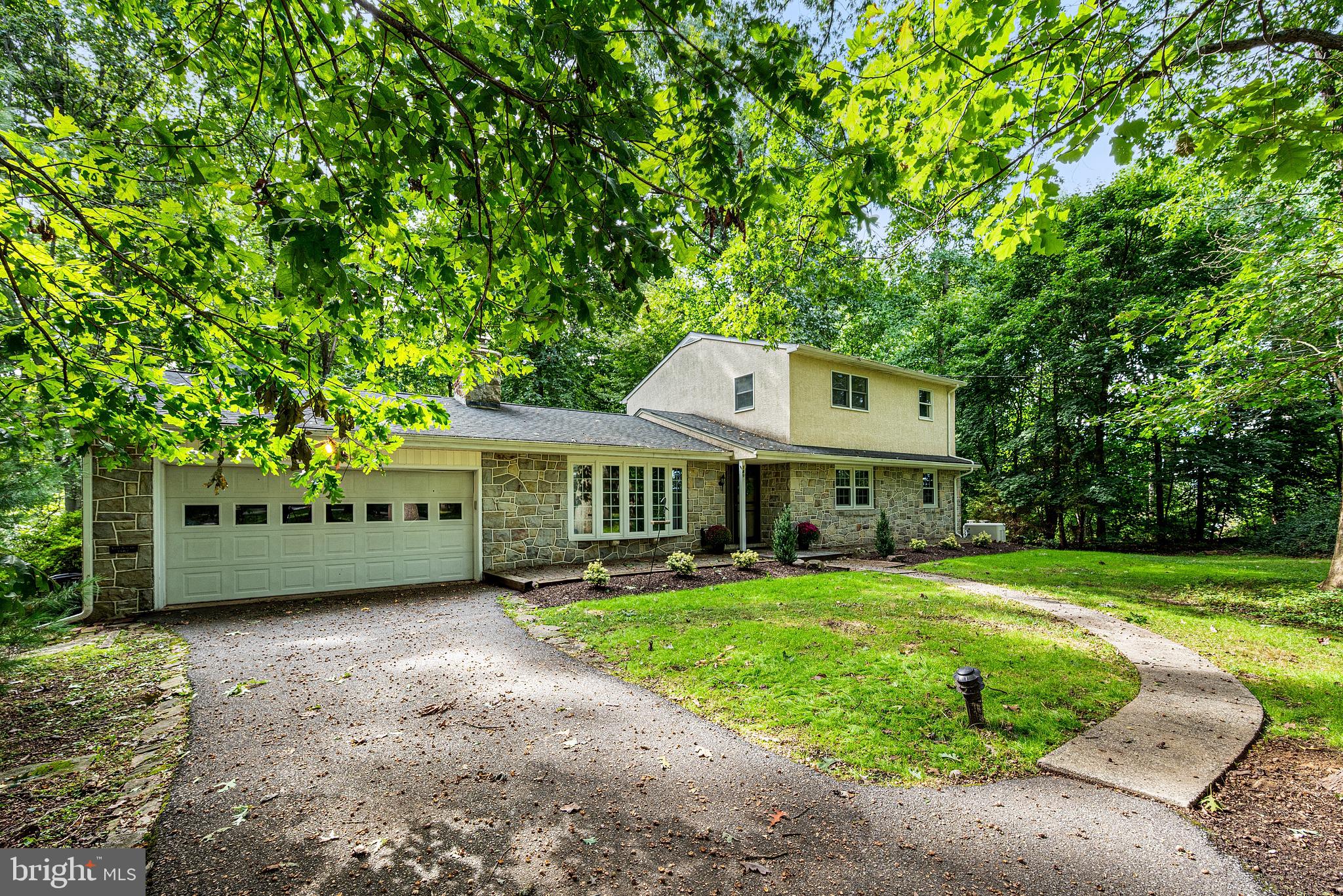 Nestled among rolling fields and lush forests, this charming move-in ready Colonial, radiates privacy and pride of ownership. Seamlessly blending traditional elegance with modern comforts, this well-maintained 2100+ sq foot residence features five spacious bedrooms and two full bathrooms on just over an acre, making it an ideal retreat for those seeking space both inside and out. Step inside to discover a warm and inviting atmosphere, highlighted by beautiful wood floors and a cozy wood-burning fireplace that serves as the heart of the living area and leads to a separate dining area. The cozy country kitchen provides plenty of cabinet, pantry and counter space. The main level also features 3 good-sized bedrooms and a thoughtfully designed full bathroom with a walk-in shower. Upstairs, you'll find two large bedrooms, a full bathroom and a spacious common-area, perfect for a playroom, home office or entertainment area. Venturing downstairs, the partially finished basement offers additional space for storage and a large finished area perfect for a man-cave, kids corner, craft haven or home gym - and with enough space for all four! Outside, the 1.1 acre lot provides ample room for outdoor activities and relaxing in the quiet privacy of a wooded lot. The attached garage accommodates two vehicles, with driveway space for four more vehicles. The brick patios at both the front and back of the home, are waiting for gatherings with friends or a quiet evening relaxing.  This home is not just a place to live; it's a sanctuary ready to welcome its next family.