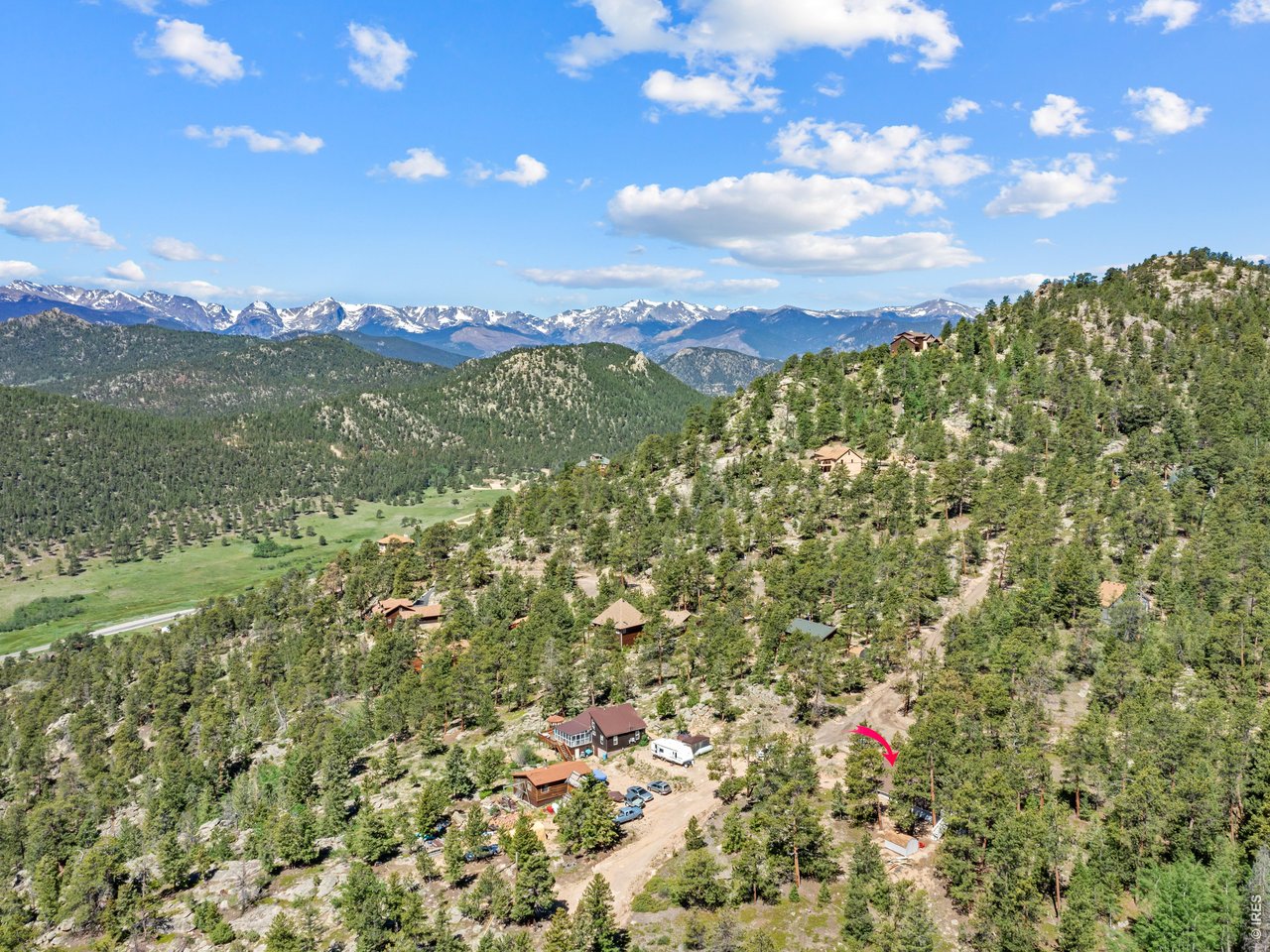 A meandering lane leads you through the forest to the perfect mountain property, with beautiful privacy across 2.82/acres of rock outcroppings and amazing views to Longs Peak, Mount Meeker and Twin Sisters! Bordering National Forest, you'll enjoy endless adventure and then retreat to this stunning cabin home with iconic A-Frame architecture, recently renovated with new flooring, updated kitchen, new appliances, thoughtfully renovated bathroom, refreshed decks, all of which beckons for company or quiet moments. Main level suite provides serenity and luxury, plus a versatile loft for visiting friends & family, tv, or home office. After sharing your morning coffee with deer, birds, turkeys, and the occasional bobcat, you'll find the gateway to Rocky Mountain National Park just minutes away, with easy access to over 350 miles of trails, cascading waterfalls, and some of the most breathtaking scenery in the American West. After a full day in the park, Estes Park's boutique shops, local restaurants, and vibrant downtown are just a short drive away... Ready to enjoy every day or every weekend, with the peace, quiet and perfection you've been waiting for...$499,000