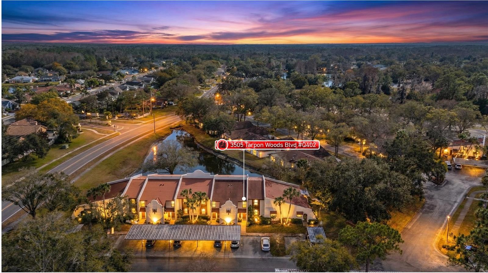 Don't miss this exceptional opportunity to own a highly sought-after GROUND FLOOR unit featuring breathtaking POND VIEWS in the desirable Tarpon Woods community. Beautifully updated and move-in ready, this meticulously maintained two-bedroom, two-bath residence combines modern luxury with serene waterfront living. Step inside to discover a light-filled, spacious floor plan showcasing premium updates throughout, including luxury waterproof wood-like flooring flowing seamlessly through the main living areas with elegant tile completing the sophisticated aesthetic. The kitchen features stainless steel appliances, modern cabinetry, and breakfast bar seating perfect for casual dining and entertaining, while the adjacent designated dining area accommodates guests with ease. The generous master suite serves as your private retreat, complete with an en-suite bath featuring a stylish step-in shower and walk-in closet. Your guests will appreciate the private second bedroom with ample walk-in closet space and adjacent updated bath with tub/shower combination and contemporary vanity. Convenient inside laundry with washer and dryer adds to the home's functionality. The oversized private patio extends across the entire rear of the unit, offering an expansive outdoor living space where you can relax and immerse yourself in peaceful pond views, watching the abundant wildlife and enjoying the tranquility of waterfront living from your ground floor vantage point—a rare find in this community. Tarpon Woods is a well-managed, maintenance-free community featuring a large pool, spa, and gazebo, with an HOA fee of $638/month providing exceptional value by covering building insurance, water, sewer, trash, basic cable, internet, reserve funds, exterior and grounds maintenance, and recreational facilities. Covered carport parking plus ample guest parking ensures convenience for you and your visitors. Ideally situated near John Chestnut Park with boat launch and Lake Tarpon access, the popular Pinellas Trail, and the YMCA, you'll enjoy proximity to top A-rated schools, award-winning golf courses, pristine beaches, outstanding restaurants, premier shopping, and cultural venues including the Ruth Eckerd Hall Performing Arts Center. Trendy downtown Dunedin and Safety Harbor are just minutes away, while Tampa International Airport is a convenient 20-minute drive. This property is NOT in a flood zone. Used seasonally and lovingly maintained, this home presents like new and is ready for immediate enjoyment. Whether you're seeking a year-round residence or the perfect seasonal retreat, this rare ground floor gem offers the ideal combination of luxury, location, and lifestyle.