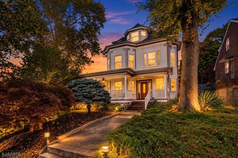 Discover timeless Victorian charm in this impressive Ridgefield residence, ideally situated on a spacious corner lot just minutes from the George Washington Bridge and NYC! Combining classic architecture, generous living space, and exceptional commuter convenience, this home truly stands apart.An expansive wraparound porch featuring beautiful mahogany flooring welcomes you inside, where soaring ceilings, oversized rooms, and charming architectural details create a warm and inviting atmosphere. Offering three expansive levels of living space, the home features 5 bedrooms and 4.5 bathrooms, including a spacious third-level primary suite with a sitting area, space for a home office, and walk-in closet.The finished lower level adds incredible versatility, featuring additional living space, a kitchen, full bathroom, and separate exterior entrance, offering flexible possibilities.Additional highlights include a detached garage, ample driveway parking, and generous outdoor space. Enjoy convenient access to Manhattan, NYC transportation, major highways, shopping, and dining.With its timeless character, exceptional space, and unbeatable location, this remarkable home offers a rare opportunity to enjoy the best of Bergen County living.
