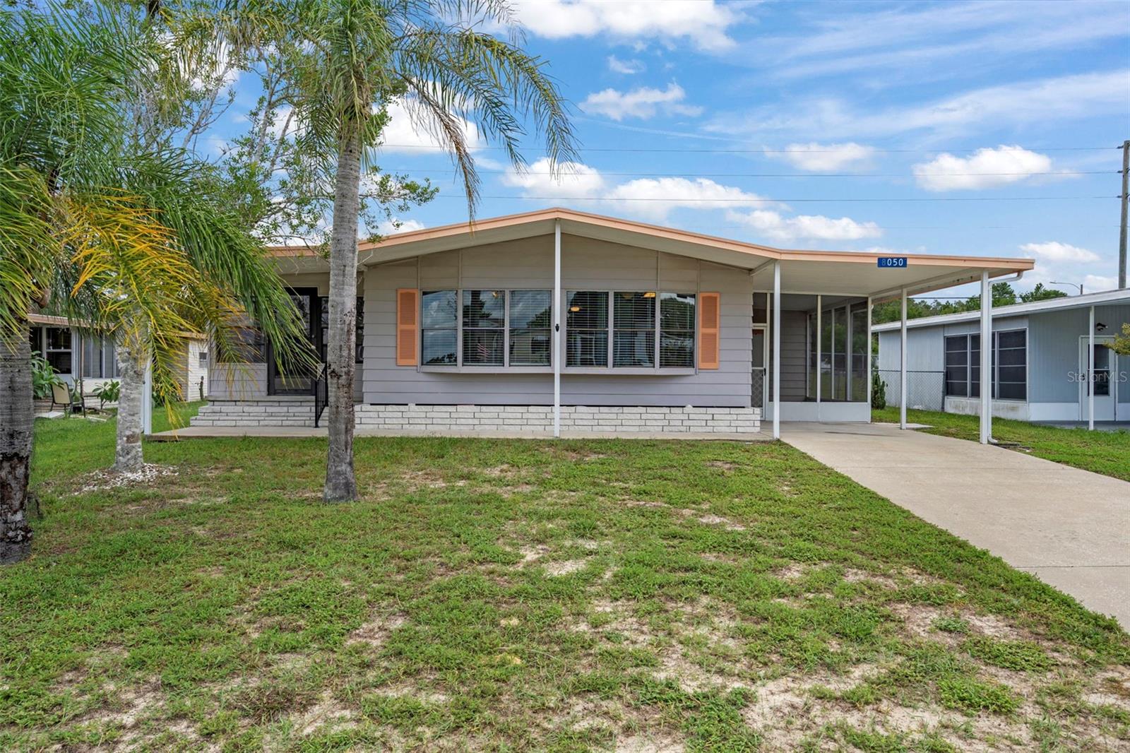 Freshly painted 2 bedroom, 2 bath home with new flooring throughout. Updated kitchen and bathrooms. High ceilings add to the open feel. Large enclosed Florida room with AC plus a screened patio for outdoor enjoyment. HVAC replaced in 2022 and roof replaced in 2017.  Located in the vibrant and active 55+ High Point Golf Community, offering tons of amenities such as Golf, tennis, pickleball, heated pool, social events and so much more. High Point is located close to shopping, restaurants, entertainment, and medical facilities. Low HOA fees and you OWN YOUR OWN LAND.