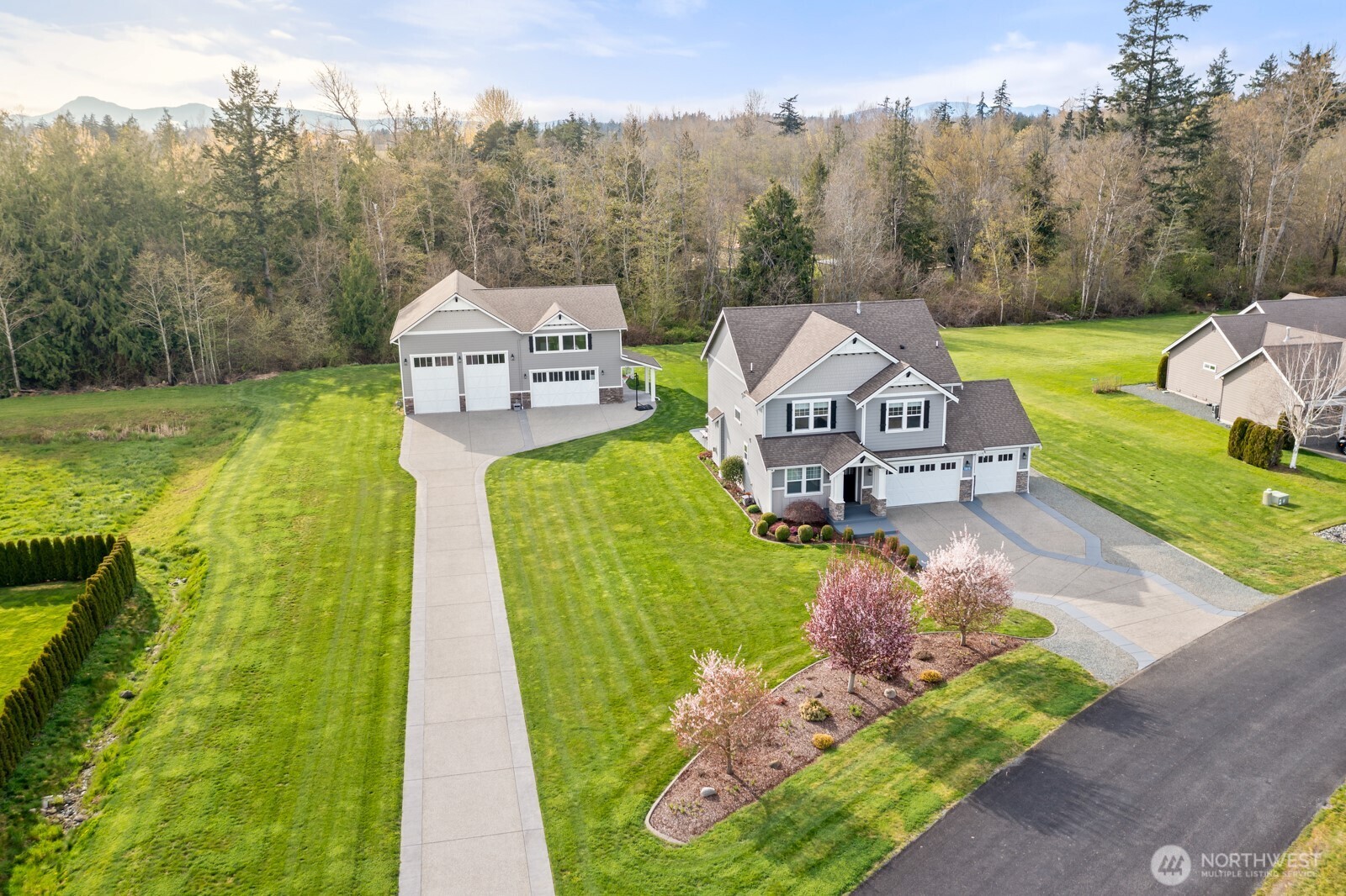 Stunning home in highly desirable area of Bay View. The main floor of this like new home features oversized kitchen, pantry, living room, gas fireplace, half bath, office with double doors as well as a very large utility room. Upper level boasts 4 bedrooms, 2 full baths and a bonus room! Primary bedroom with 5 piece en-suite with large walk-in closet. Home sits on nearly an acre with a 52x42 shop, 14 ft doors and aggerate concrete entrance. Above the shop is a 900 sqft living space with stylish finishes. This Studio is 1 bed/1 bath, kitchen with island, quartz counters, living room, ductless mini-split, tankless water heater, radiant heat as well as washer/dryer hook ups. Outside you will find a patio with stamped concrete and garden area perfect for entertaining. Home backs up to treed land for privacy. You won't be disappointed!