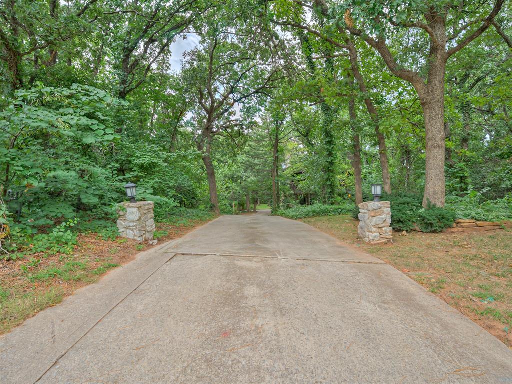 OPEN SATURDAY 1-5 & SUNDAY 2-4!! You won’t find many homes like this in Edmond. Nestled on a fully wooded half acre lot (mol), this exceptional property offers the rare combination of total privacy and the charm of a mountain lodge—right in the heart of town. Surrounded by towering trees, birdsong, and the gentle rustle of leaves, this beautifully updated home feels like a peaceful retreat from the everyday. Freshly painted and solidly built, the home welcomes you into a warm and inviting atmosphere. The living room features rich wood floors, a cozy fireplace, and expansive windows that frame stunning views of your natural surroundings—like having a living landscape painting right outside your door. The dining room flows seamlessly into the kitchen, where stainless steel appliances, generous countertops, and a nearby laundry area make for easy everyday living. A convenient half-bath is also located on the main level. Upstairs, you’ll find an open study area with custom bookshelves—ideal for a home office or reading nook—along with two spacious secondary bedrooms connected by a Jack and Jill bathroom. The primary suite is a true sanctuary: bathed in natural light, it offers private balcony access overlooking the trees, built-in workspace, an en-suite bathroom with walk-in closet, shower, and abundant storage. Step outside to discover your dream yard. The fully wooded lot provides serene privacy and features a seasonal creek that adds to the tranquil, almost storybook setting. Whether you envision outdoor entertaining, quiet evenings on the deck, or a nature-filled play space, the possibilities here are truly endless. Don’t miss this unique opportunity—homes like this rarely come on the market in Edmond. Schedule your private tour today.
**Seller is offering a \$2,000 credit toward an oven replacement of the buyer’s choice.**