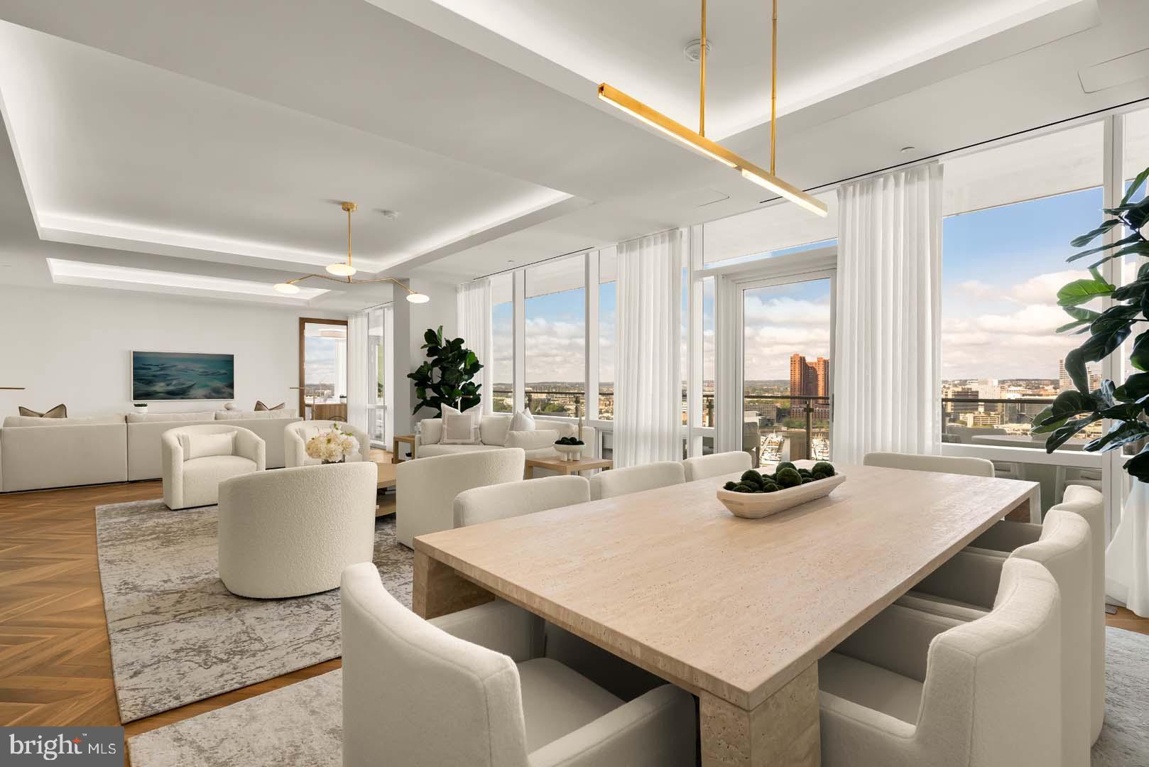 BRAND NEW SHOWCASE MODEL - TWO BEDROOM + DEN  + OFFICE W/ BALCONY AVAILABLE!Welcome to the Four Seasons Private Residences in Harbor East, where luxury meets lifestyle in Baltimore’s most coveted waterfront address. This stunning two-bedroom, two-and-a-half bathroom newly furnished model comes with designated den and office spaces, and was thoughtfully designed to maximize every inch, making it live far larger than its 2,772 sq ft. Step into an atmosphere of sophistication with soaring ceilings, rich walnut chevron-patterned flooring, and curated designer finishes throughout. Expansive floor-to-ceiling windows flood the home with natural light and offer breathtaking views of the Inner Harbor and iconic Domino Sugar throughout. The open-concept living and dining areas flow seamlessly into a gourmet kitchen outfitted with Miele appliances, sleek Eggersmann soft-close cabinetry, luxurious marble stone countertops, and a built-in Sub-Zero wine fridge. Just steps away, a wet bar equipped with an ice maker and an additional wine fridge adds convenience and elegance, ideal for entertaining. The primary suite is a tranquil retreat, featuring a massive walk-in closet and a spa-inspired, marble-clad en-suite bath. Enjoy a double vanity with designer finishes, private water closet, glass-enclosed walk-in shower with a built-in bench and niche, and a sculptural freestanding soaking tub that invites total relaxation. A dual-access balcony (accessible from both the living area and the primary suite) offers the perfect perch to take in harbor views and fresh air. The spacious den provides flexible use as a library or media room, and the additional sun-soaked office space offers the perfect setting for productivity and inspiration. Every space is enhanced by motorized window shades and expansive views that change with the light.The Four Seasons Private Residences Baltimore offers a turn-key elevated lifestyle. As a resident, you'll enjoy a private entrance where you will be met by our full service concierge and on-site building manager to assist with your every need, as well as exclusive access to the sprawling 28th-floor amenity level, where world-class services meet resort-style indulgence. Amenities include an indoor heated saltwater infinity-edge pool, a state-of-the-art fitness center, sauna, coffee station, billiard room, and numerous elegant gathering spaces. Multiple rooftop decks offer panoramic city and harbor views, complete with indoor and outdoor fireplaces, a grilling station, a dining area, and a kitchen, all ideal for entertaining. Additional perks include a fully equipped conference room and a dedicated AstroTurf dog-walking area. This residence offers the rare opportunity to live within a full-service, hotel-branded building while enjoying the privacy and sophistication of a true luxury home. All set within steps of Harbor East’s acclaimed restaurants, shopping, and the waterfront promenade. This is a MUST SEE TWO BEDROOM + DEN + OFFICE!! Immediate occupancy is available. Come see what all the fuss is about!