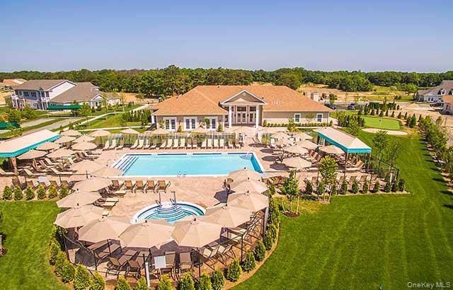 THIS PARTICULAR UNIT BOASTS SUPERIOR LOCATION,LOCATION,LOCATION AND UPGRADES BABY UPGRADES!!Welcome to The BEDFORD a desirable ground floor model Located in The Manors at Colony Preserve! Your Ultimate Haven in the Heart of a coveted 55 and Over Community! Luxury living, meticulously crafted two-bedroom unit, Beautifully Upgraded, Including granite Counter tops,Recessed lighting, two full bathrooms, Updated Appliances, Sliders to your Private Patio, Beautiful sprawling tile floors and full garage with custom epoxy flooring and 220 EV Charging system . Situated in an enviable location just steps from the clubhouse gym and pool , as well as breathtaking wide open unobstructed views to the lake! Enjoy The upgrades and attention to detail with crown molding, able clean air system, garbage disposal, gas stove ,Brick covered patio upgraded appliance package. Take note of the "two" water spickets for  convenience,! If your going to do something do it right ! One water source in the garage and one on the patio as well! Instant hot water heater and custom closets!The location of "This particular Bedford unit" offers the epitome of convenience and comfort with beautiful views! Indulge in top-of-the-line amenities including a shimmering pool, relaxing Jacuzzis! Enjoy a lifestyle of unparalleled ease, every need is met effortlessly. TIME TO DITCH THOSE SHOVELS, RAKES AND LAWN MOWERS! Those days are now over! Experience the relaxation with well-manicured bocce courts, serene walking trails around a picturesque lake, and charming gazebos scattered throughout the community. The immaculate clubhouse beckons with its state-of-the-art gym, life fitness center, game rooms, library, and inviting social events calendar! You'll be "feet in the sand" in minutes as your only 2 miles from Smith Point Beach, Tiki Joe's and the breathtaking Atlantic Ocean! Take a breath of fresh air on your private patio and soak in the tranquil surroundings. Isn't it time to experience a hassle-free lifestyle? Simply turn the key and let The Manors take care of the rest. As a dedicated realtor for 28 years, I wholeheartedly stand behind the exceptional value and lifestyle offered by this 55 and over community. In fact, I am so confident in its merits that I proudly facilitated the purchase of a home for my own parents within this esteemed Community! With top-tier amenities, a vibrant social atmosphere, and a commitment to providing residents with the utmost comfort and convenience, this community embodies everything one could desire in their golden years. I invite you to explore the countless benefits. The BEDFORD at Colony Preserve, your new home sweet home. You've been around long enough to know opportunity is not a lengthy visitor!