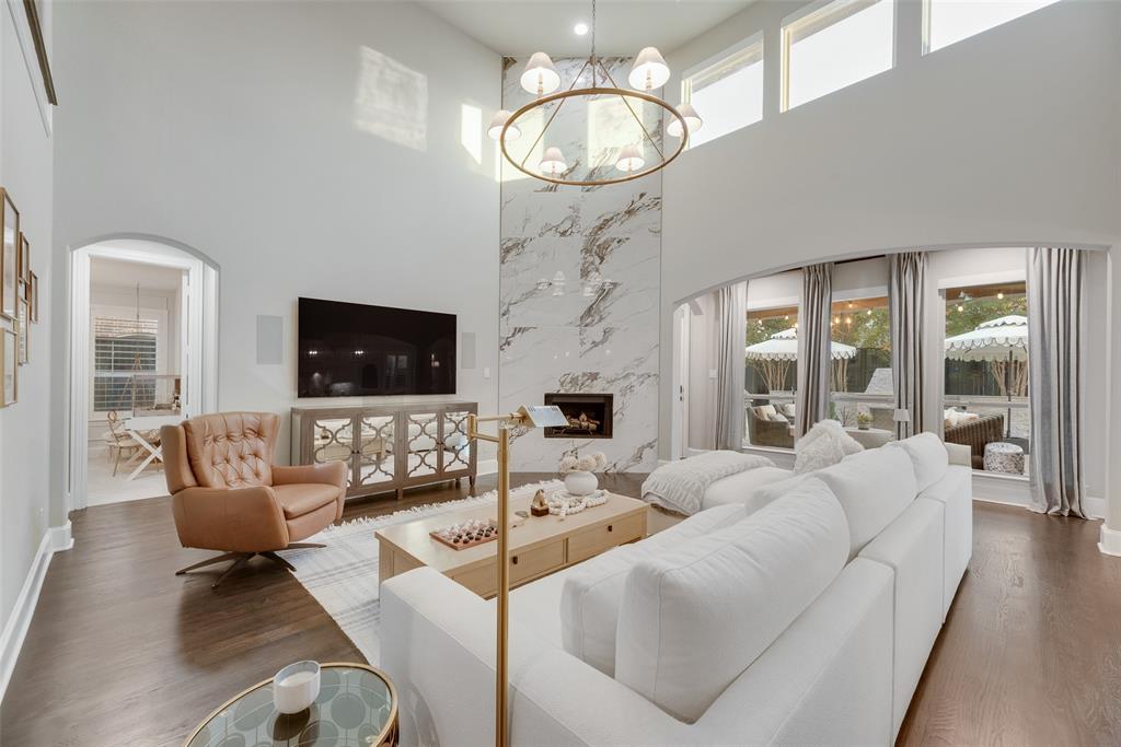 Nearly 300k in upgrades in this single-owner, fully updated West Frisco home. With designer finishes in every room, this north facing 4 beds, 3.5 baths showstopper includes a private office, game room, media room and a custom outdoor living space. From the foyer you get resurfaced wood floors, updated iron stair railings and plantation shutters that carry through the house. The front office is a showpiece with picture-frame paneling, designer paint and a statement light. Formal dining has tall windows and a Visual Comfort chandelier.

The kitchen was updated with painted white cabinets, Taj Mahal counters, farmhouse sink, marble backsplash, tile floors, Bosch dishwasher and stylish pendants and opens to the two-story living room. That space features a floor-to-ceiling fireplace wall, grand windows overlooking the backyard and another designer chandelier — perfect for daily living.

Downstairs primary suite feels like a hotel: picture-frame wall detailing, large windows with shutters and a luxury bath wrapped in marble to the ceiling with freestanding tub, frameless shower and gold fixtures. Laundry room was also remodeled with custom cabinets, counters and a utility sink. Secondary baths, including the downstairs guest bath, were also updated.

Upstairs you’ll find a framed-out media room with projector and surround sound and a game room with Restoration Harware chandelier. Outside is your second living room with an extended, tile patio with stone wall, wood-burning fireplace, chandelier and mature trees. Home features newer roof, custom iron door and garage with coated floors and storage. Meticulously maintained and truly move-in ready.