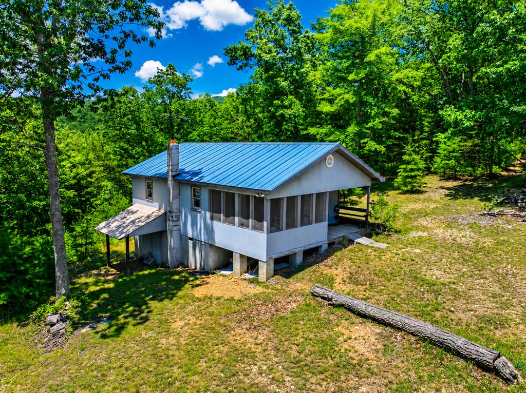 YOU FOUND IT: Raw Unrestricted Mountain Land & livable Cabin (AS IS) on the ultimate 29+ rural pioneer style acres high atop private Gator Mountain Rd in Dugspur Va. The small 2-bedroom, 1 bath cabin has water, power, septic and is included in the price of this raw land. What's on your wish list? Seclusion, privacy, big game wildlife, wild berries, mixed topography, peaceful setting, quiet, hunting, hiking, ATV trails, 4 wheeling, camping, a gathering place for family and friends, homesteading, grow your own food, seek to build your own vision of an ultimate retreat get-a-way destination, are you a survivalist... well ITS ALL HERE on this large land tract in the heart of the Blue Ridge Mountains in Southwest Virginia. A place where the outdoor nature lovers come to refuel their spirit and souls. You want to enjoy life from a simpler time in a world less chaotic and away from the noise... this land checks ALL THOSE BOXES. The property is unrestricted, 4WD highly recommended as you travel a mile or so on this shared gravel road w/2 other like-minded care takers of Mother Nature's little gem here. This is a pioneer experience and quite UNIQUE and rarely becomes available for sale on the open market. The land is crawling with wildlife: deer, turkey, grouse, fox, bears, rabbits and all their counterparts as wild berries & natural perennials are abundant and the magnet for them to thrive. Although access may "appear to not be for the faint of heart" on your first excursion, you will see it is in good shape & totally accessible with 4WD truck or SUV. You will have to drive over a small creek to cross the road, but it is shallow & quick to cross (about 8 feet or so). The land is mostly wooded, there is no road maintenance agreement, (just a handshake of good will) the driveway once you enter through marked on right with 640 is steep but again, kick your vehicle into 4WD and you are good to go. Sellers enjoy seeing the wildlife on all their trail cams so smile & wave.