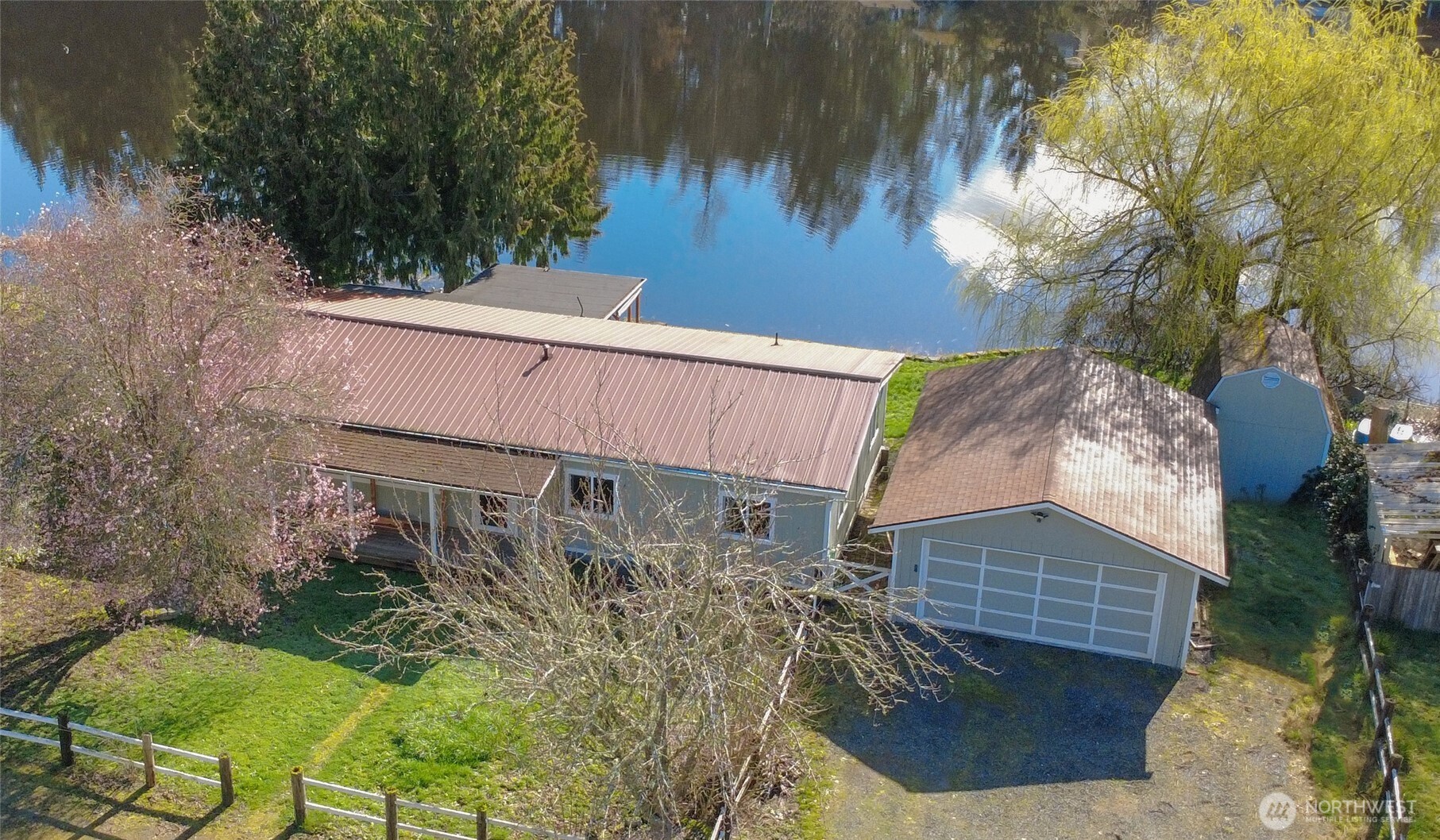 Dreaming of living on a lake? Here is a tranquil lake house ready for a new owner. Fish from your back yard, there's great bass fishing! Situated on the banks of Lake Serene, this home is equipped with a 4-tiered deck, perfect for sipping morning coffee or hosting a BBQ. Walk just a few feet from your back door and take a swim in the lake or have a bonfire in your lake-side fire pit. Other amenities include 2 separate living areas. The primary bedroom is huge with it's own private bath. Home has a pellet stove for low heating bills. You've got A/C and double and triple paned windows to keep energy bills low! A large 2 car garage w/ workspace, and 2 storage sheds.