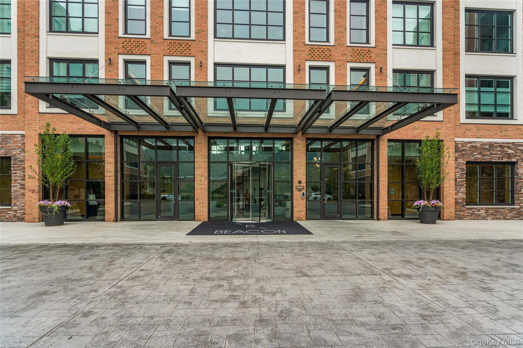 GLEN COVE. Luxury living at its finest, within the Beacon at Garvies Point; nestled on 56 acres of waterfront, residence 1309, an exquisite 2 bedroom, 2 full bathroom Penthouse, features high ceilings, wall to wall windows offering all day sun and views of the marina, and your own private rooftop terrace, which has been customized like no other; including a full outdoor kitchen, gas bbq and fire pit, outdoor entertainment and outdoor shower. With an open floor plan, extensive upgrades and customizations, as well as all the amenities and comfort the Beacon has to offer; paths, courts, marinas, beaches, dog parks, and much more.