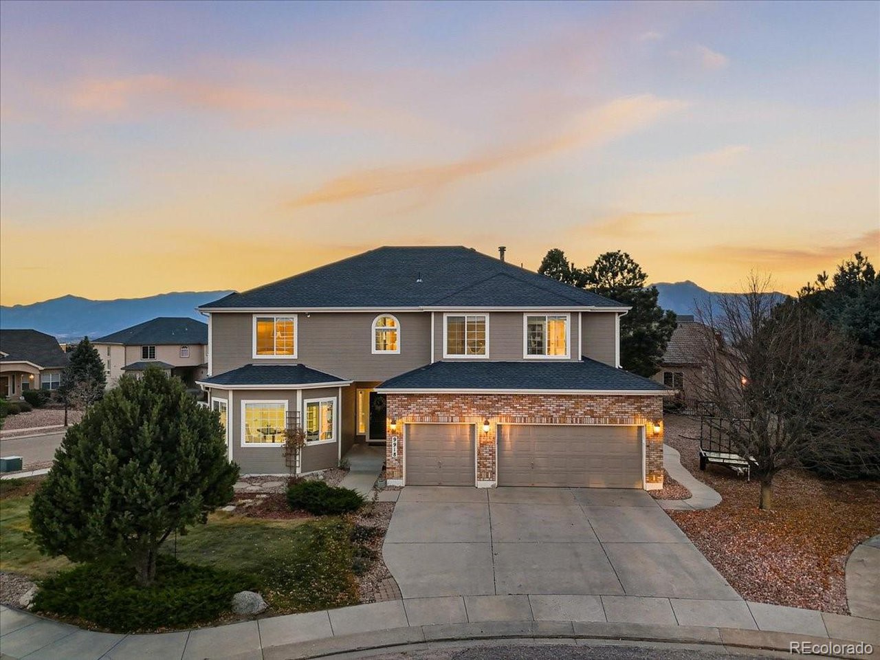 Experience Colorado luxury living in this elegant 2-story home tucked into a quiet cul-de-sac in the sought-after District 20 Pine Creek High School area - where location, lifestyle, and luxury come together. This Charter Greens beauty in the heart of Briargate features 4,645 sq ft, thoughtfully designed living spaces, luxurious upgrades, and incredible Pikes Peak views. Inside, you're welcomed by soaring ceilings, mountain views, and abundant natural light. Whether enjoying your morning coffee in the sunlit kitchen or winding down while watching the sunset behind Pikes Peak, this home invites relaxation and inspiration. The stylish and functional kitchen boasts granite countertops, a large island with bar seating, and open flow into the living and dining areas-perfect for gathering and entertaining. A cozy fireplace adds warmth and charm for cozy nights and relaxed weekends. Unwind in the sprawling primary suite offering its own fireplace, a spa-like 5-piece bath, and a massive walk-in closet. Large windows frame Pikes Peak and the Front Range. Two spacious bedrooms with walk-in closets, and laundry room with sink complete the upper level. Need a quiet workspace or work from home? Head to the home office with French doors for privacy or an open, inviting feel. The star of this home may be the finished basement with an expansive Theater Room wired for a projector, rec space with its own fireplace, and large extra bedrooms ideal for workout space, teens, guests, or extended family. Whether it's movie night, game day, or a quiet spot to recharge, there's room for it all. Step outside to a landscaped backyard and elevated patio with sweeping views of Pikes Peak and the Front Range-ideal for grilling or sunset lounging. This home also includes central A/C and paid-off solar for energy-efficient comfort year-round. Close to parks, shopping, entertainment, restaurants, and trails, just minutes to Air Force Academy, and I-25, this is more than a home, it's a lifestyle.