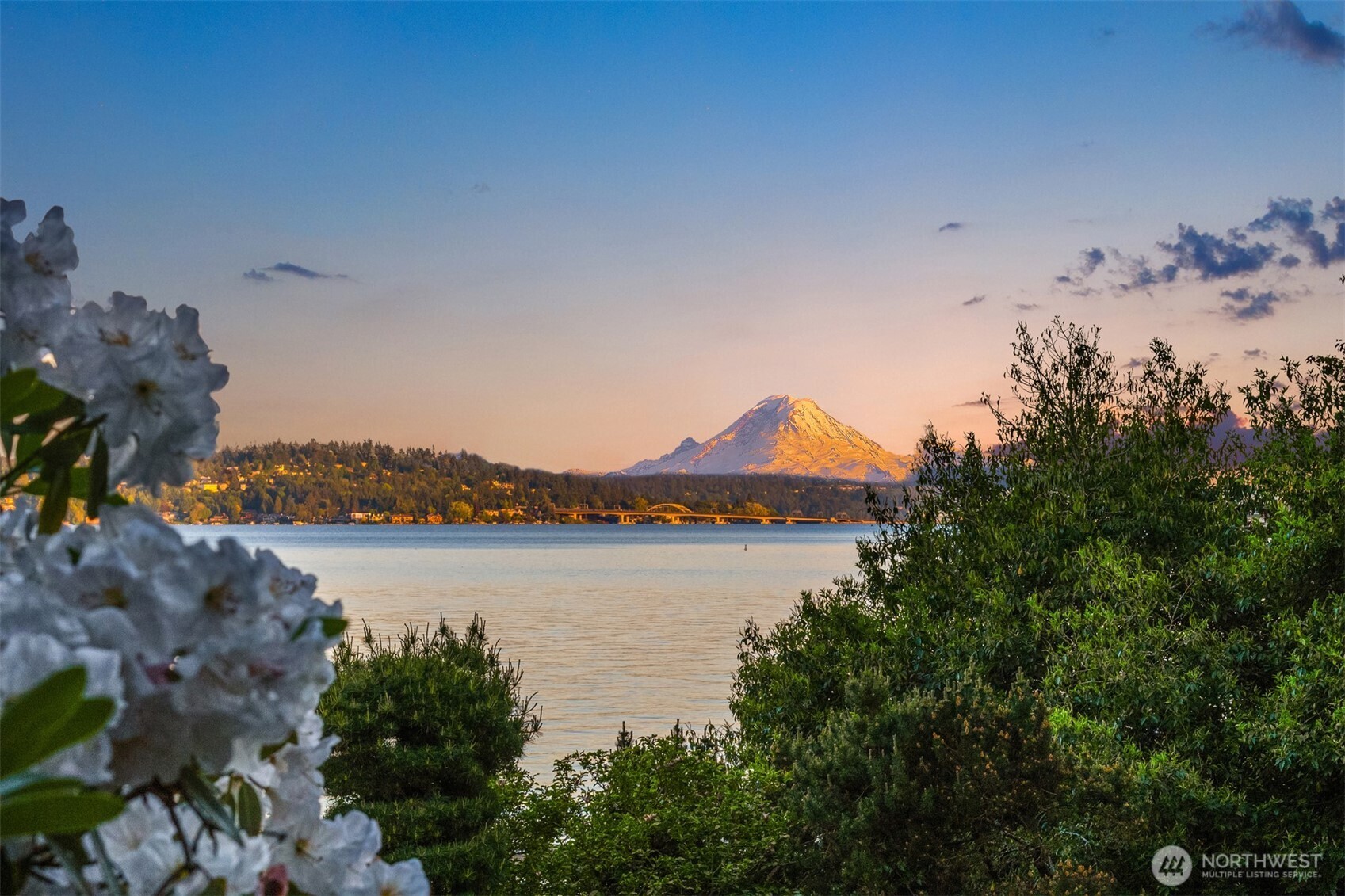 Your own In-City Lakefront Resort! Rare offering of this extraordinarily private & expansive 120 ft no-bank Lake Washington estate w/ level lawn, lush grounds, swimming pool, hot tub, dock & sauna. - One of only few no-bank waterfront homes in excellent Washington Park location. Expanded and completely remodeled to take advantage of Mt Rainier, Cascade Mountains, Bellevue skyline, sunrises and moonrises through the countless oversized windows.  Open concept home w/ perfect indoor-outdoor flow: rooms open to the sprawling lawn & pool terrace through the many glass doors, all rooms look onto the stunning setting and mature gardens. Paneled living room, sandstone fireplaces, Carrara marble kitchen, Family room, Pool cabana room, all with relaxed yet sophisticated beachside character. Glorious primary suite w/ vast closet space & marble 5-piece bathroom, private office, two dressing rooms. Flexible floor plan affords privacy in choice of bedrooms. Choice location near Madison Park shops, restaurants and parks. 2 air conditioners, Steam shower. No detail has been overlooked! Come enjoy the best Lake Washington has to offer.