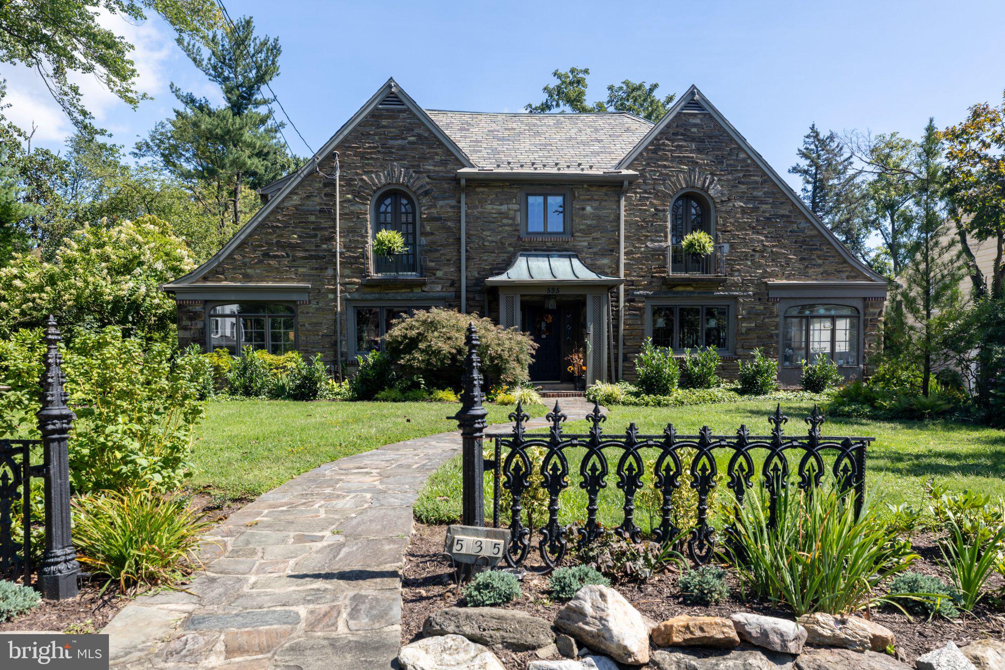 Discover a timeless stone Tudor nestled in the prestigious Wynnewood neighborhood. This spacious residence, built in 1930, boasts 3,970 sq. ft. of elegant living space, featuring four bedrooms and three and a half bathrooms. Hardwood and tile flooring throughout exudes warmth and sophistication, while two charming fireplaces create inviting focal points in the living areas. Outside, the expansive 0.48-acre lot with mature gardens provides ample room for outdoor activities, while the detached three-car garage ensures ample parking and additional storage. Experience the perfect blend of classic architecture and modern comfort in this well-maintained home, ideal for those seeking an exclusive lifestyle in a vibrant community. Embrace the opportunity to make this stunning property your own and enjoy the luxury it has to offer.