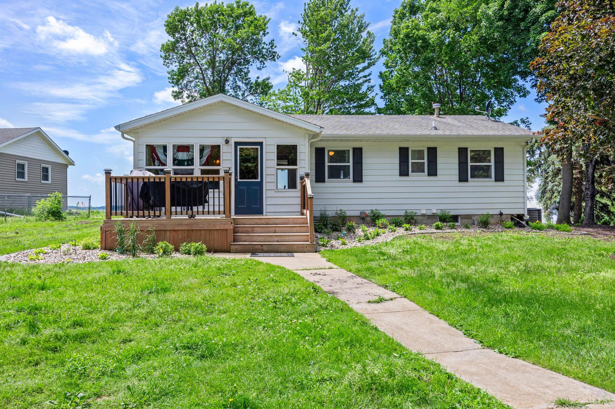 Experience lake life at its best on beautiful Sauk Lake! This charming 3 bed, 2 bath home offers stunning water views, direct lakeside enjoyment, and the perfect blend of comfort and recreation.A welcoming front porch leads into a warm and inviting sunroom with wood plank walls, creating the ideal space to relax year-round. The kitchen features stainless steel appliances, and abundant cabinetry, while the adjoining dining area provides a convenient everyday gathering space.The living and dining rooms showcase breathtaking lake views and walk out to the deck and backyard, creating seamless indoor-outdoor living. Two main-level bedrooms and a fully updated bathroom (2023) offer main-floor convenience.The finished lower level features a spacious family room with an electric fireplace, a third bedroom with built-in desk, a ¾ bath, and abundant storage.Outside, enjoy a detached 3-car garage with workbench and shelving, plus a versatile bunkhouse perfect for guests or hobbies. Recent landscaping improvements, hydroseeded lawn, and newly planted trees enhance privacy and curb appeal. Whether you're seeking a year-round home or a weekend retreat, this move-in ready property delivers incredible lake views, flexible living spaces, and access to everything Sauk Lake and Sauk Centre have to offer.