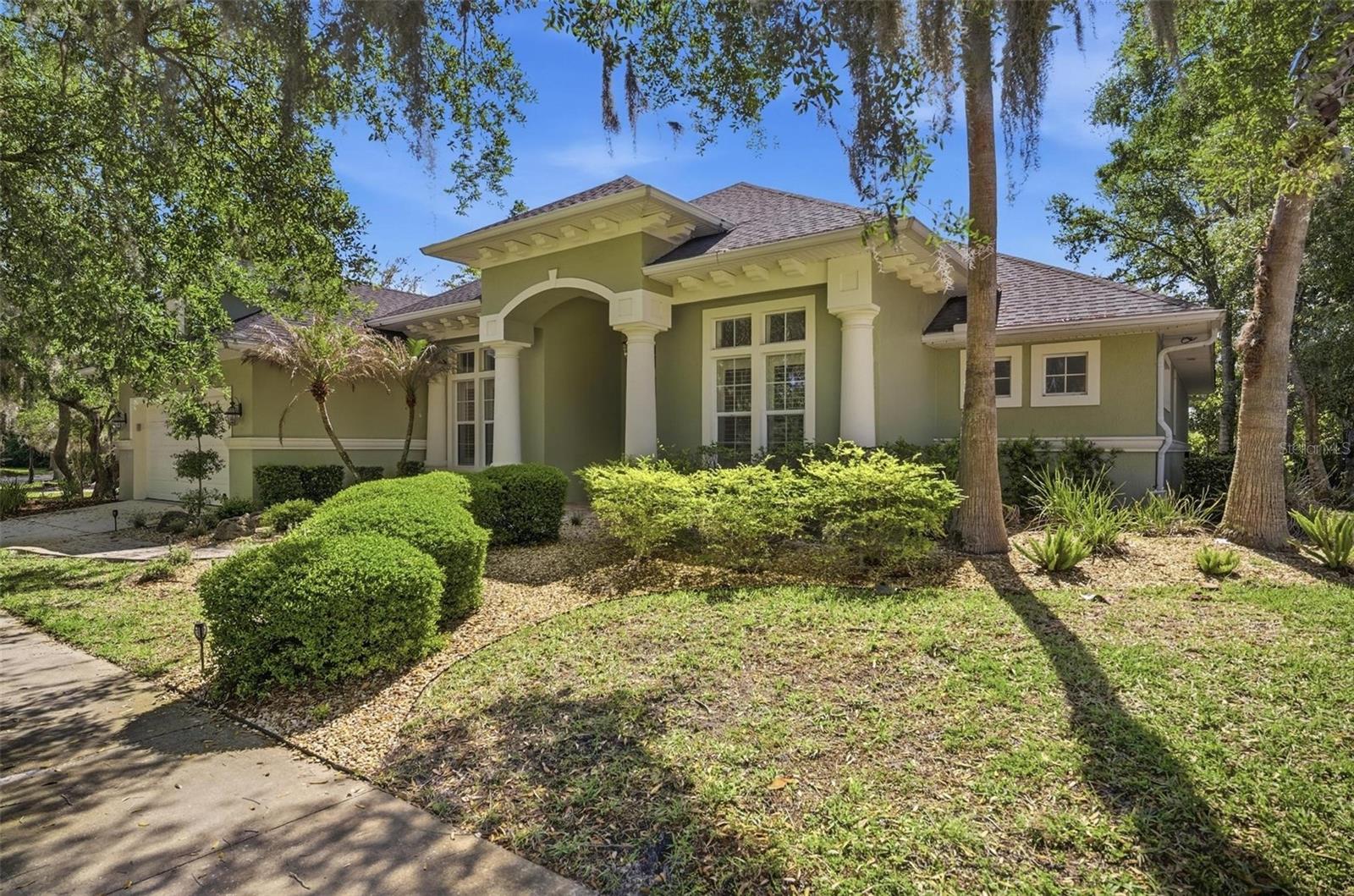 Welcome to this luxury former model home in the highly sought-after Grand Haven community, offering 4 bedrooms, 3 baths, and 2,952 sq ft of thoughtfully designed living space. This 2005 Parade of Homes "Award of Excellence" award-winning “Sweetwater” floor plan has been extensively renovated in 2024 with high-end finishes throughout, plus a newer roof (2022). Inside, soaring 14' tall tray and coffered ceilings, an abundance of natural light, and luxury vinyl flooring throughout the home, including bamboo flooring in one of the bedrooms, modern 3D tile accent wall, fresh interior paint, a see-through gas fireplace that elegantly connects the living and dining spaces. The kitchen features upgraded premium granite countertops and backsplash (2024), 42’ wood cabinetry, a 1-year smart induction range with built-in air fryer, an oversized center island, and large walk-in pantry. The primary suite is privately positioned off the pool and offers an extra-large walk-in closet and a refined, spa-like bath with a freestanding soaking tub, a ceiling-to-floor Italian porcelain tile accent wall, dual arched showers, brushed nickel finishes throughout, and its own dedicated water heater. All three bathrooms have been upgraded with Spanish porcelain tile, granite vanities, and premium fixtures. Outdoor living is effortless with an LED lit UV-upgraded pool inside a 1-year lanai screened enclosure, and a serene lake view. Additional upgrades include laundry cabinetry, plantation shutters, designer lighting, 8’ interior doors, and a paved driveway. Located in gated Grand Haven with access to golf, tennis, pickleball, bocce, fitness centers, pools, and the Tiki Bar Cafe. Conveniently located close to shopping plazas, restaurants, and bike trails, with easy access to interstate I-95 and scenic Route A1A. It’s just a short drive to the beach and the Intracoastal Waterway. Schedule a showing today and prepare to fall in love with this move-in ready exceptional home!