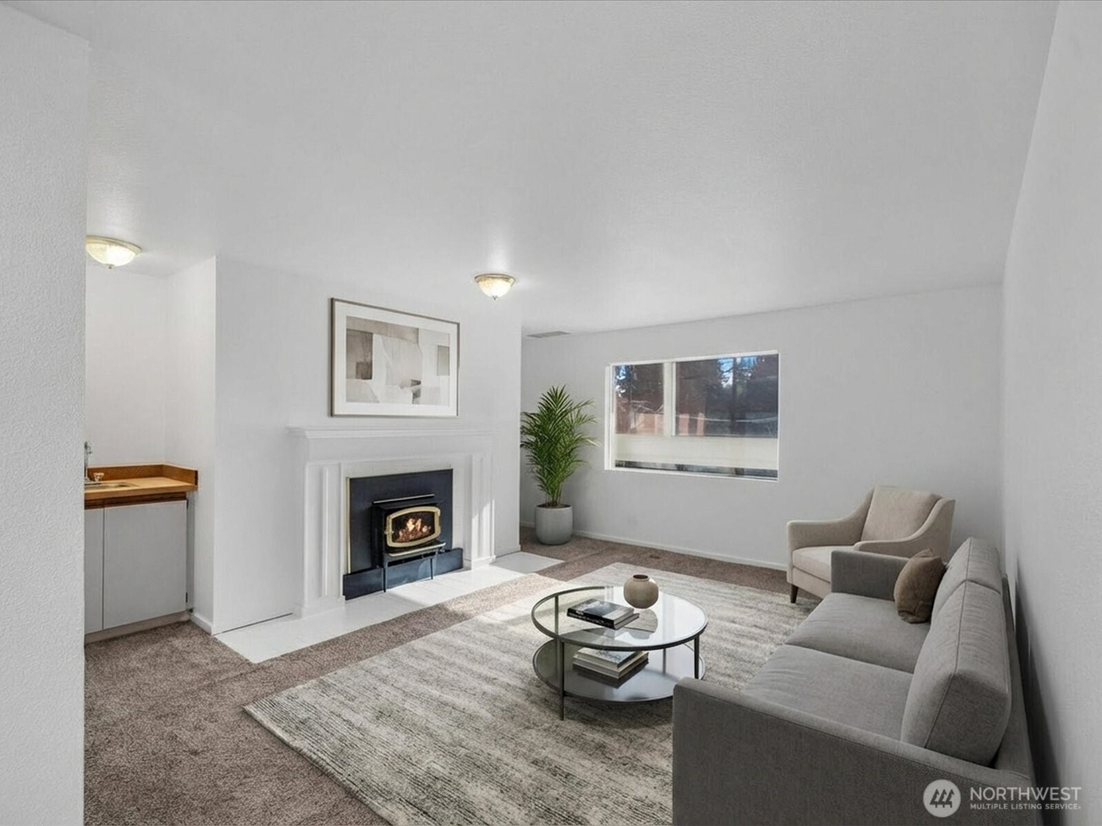 Welcome home to this light-filled top-floor Edmonds condo, ideally positioned on the sunny west-end corner of the building. Fresh interior paint and like-new flooring create a crisp, move-in-ready feel throughout. The spacious living room features a cozy wood-burning fireplace and wet bar, perfect for both relaxing evenings and entertaining guests.  The generous primary bedroom offers an oversized closet and private balcony, while a second bedroom and full bath provide flexibility for guests, work-from-home space, or additional living needs. The spacious kitchen with eating area is a true blank canvas—ready for your creative vision and personal updates.  This unit includes a 1-car garage plus an additional parking space. Pets welcome up to 40 lbs, and the community is investor-friendly with rental availability - below the rental cap.  The location is hard to beat—just one block from Five Corners, with easy walking distance to Edmonds High School and Swedish Edmonds Hospital, and only minutes to the Edmonds waterfront, beaches, parks, dining, and shopping. A short drive or bike ride puts everything Edmonds has to offer right at your fingertips.  A fantastic opportunity to live, invest, or customize a home in one of Edmonds’ most convenient and desirable locations. HOME WARRANTY INCLUDED!