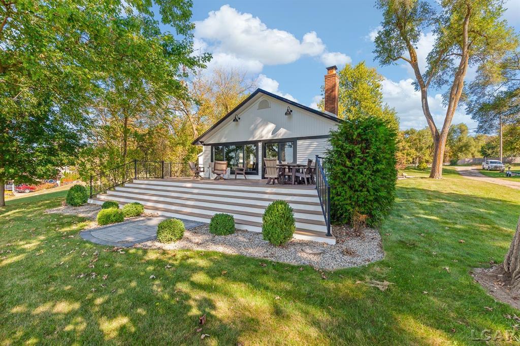 Completely remodeled Devils Lakefront Cottage with 80' of waterfront, approx. 1800 sq. ft. 3BD 2 BA on more than 1/2 acre of outdoor living space.  This home features 5 lots on a dead-end street for privacy and solitude with ample parking for all your visitors behind the house in the green space between the house and smaller shed.  Plenty of room for a garage and/or carriage house.  80' of beachfront with additional patio space nearby for enjoying all this beautiful property has to offer.  The interior has been updated throughout, new windows and doors, electrical, plumbing, lighting, additional blown in insulation, outdoor shower hookup with drain, new paint, flooring, 15x30 composite Timbertech decking with railing and professional illumination surround, landscaping, hardscaping, water softener with reverse osmosis system, Navien instant hot water system, electric fence for pets remain.  The interior includes a 25x25 loft area with enough space for 3-4 twin beds and storage with additional a/c space unit for comfort.  The exterior includes a 12x30 prefab shed insulated with electrical includes space with a/c unit for three season comfort to store all the water toys, overstock space for food and pantry items along with a 12 x 12 room for gaming, overflow overnight guests, home office, hobby room, exercise/yoga/pilates space or play area.  Additional shed on property for storage of yard items included.  All stainless steel kitchen appliances to remain.