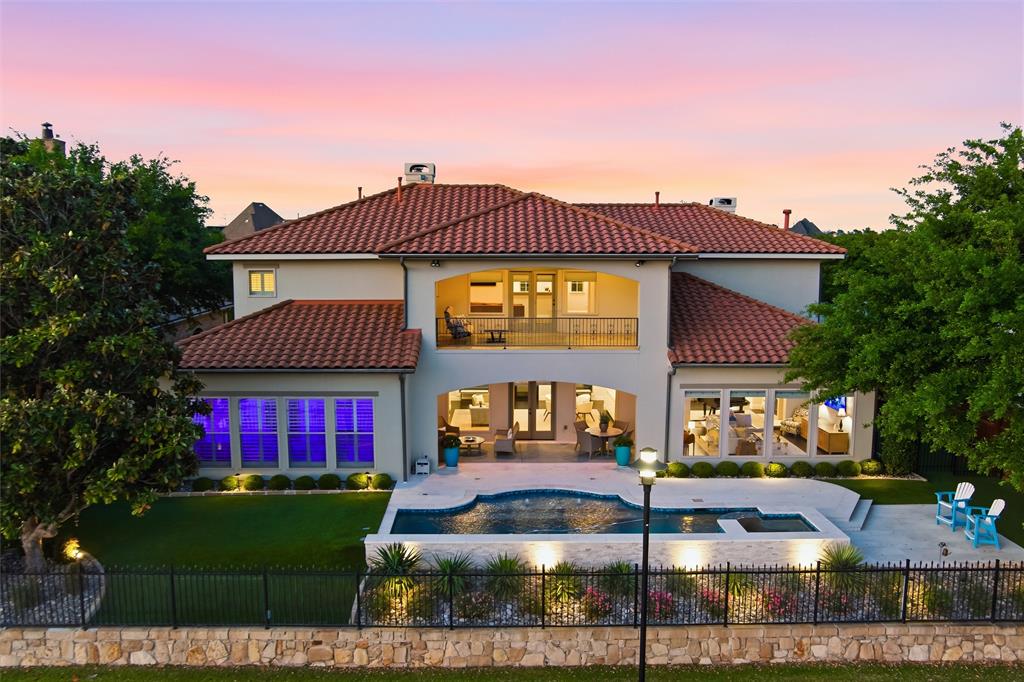 Discover the epitome of luxury in this rare 5-bedroom, 6-bathroom estate nestled in the exclusive gated community of The Lakes of Las Colinas. This stunning freshly renovated home backs directly onto picturesque Lake Carolyn, offering serene water views that define effortless elegance. Step through the enchanting courtyard and enter a private oasis designed for sophisticated living and effortless entertaining. Built with a custom floor plan and fully renovated, the residence showcases premium upgrades throughout. The heart of the home is the gourmet chef’s kitchen, featuring exquisite countertops, top-of-the-line Viking range, oversized fridge and freezer, convenient access to the butler’s pantry and an office that could be used as a 5th bedroom. Seamless flow connects the open-concept living, family, and dining areas, all framed by breathtaking lake views—ideal for hosting memorable gatherings or quiet evenings by the water. Retreat to the expansive primary suite, complete with its own stunning water views and a spa-inspired bathroom that invites pure relaxation. Upstairs continues to impress with two generous secondary bedrooms sharing a Jack-and-Jill bath, a dedicated media room perfect for movie nights, and a guest bedroom with its own private full bath. Recent changes include a substantial pool renovation with new equipment, new 3 stage HVAC units, standby generator, refreshed bathrooms, as well as numerous internal updates. This exceptional property blends timeless architecture, modern luxury, and resort-style living in one of Las Colinas’ most sought-after enclaves. Experience the ultimate waterfront lifestyle where every detail has been thoughtfully curated for comfort and distinction.