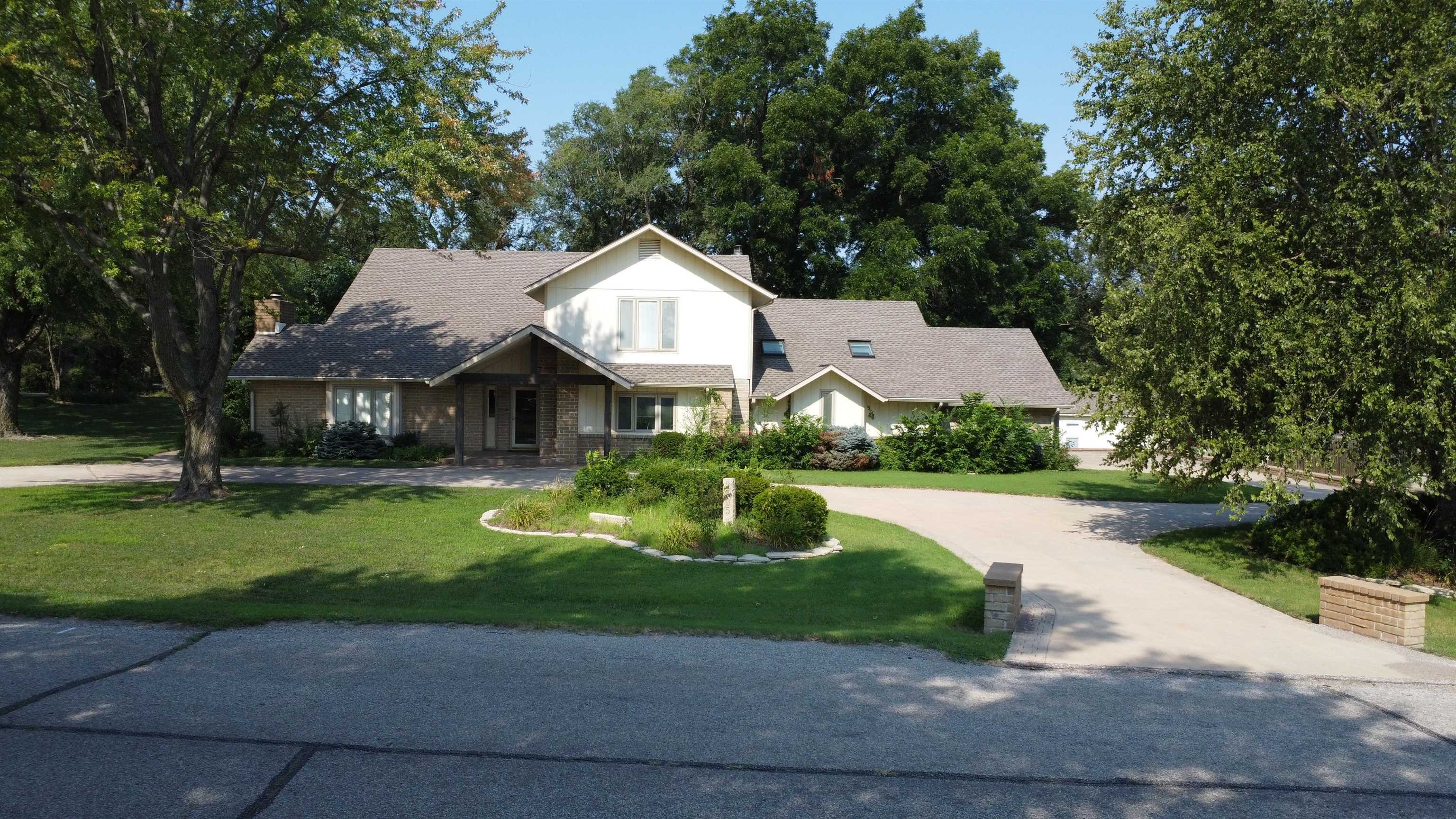 This is YOUR dream home!!!! It is a stunning five bedroom residence designed for comfort, convenience and style. Located on a beautiful corner lot with a circle drive to the front door, this property boasts an array of perfect features. Step inside to discover a spacious living room with a cozy fireplace, a formal dining room and huge kitchen that opens to a large breakfast room. The expansive family room offers plenty of space for relaxation and fun. The massive master suite is conveniently located on the main level and features an impressive walk-in shower and an enormous amount of closet space and storage. Additional highlights include:  -Laundry facilities on the main level for convenience -Safe room on main level -Oversized two car garage -Four additional large bedrooms on upper level -Loft area with office space -Solid doors throughout for added privacy and security -Beautifully crafted windows allowing plenty of natural light -Many rooms with gorgeous hardwood floors -Screened in porch to enjoy the serene surroundings  Located within walking distance of the High School, tennis courts, football field, baseball diamonds. Enjoy the quiet of this neighborhood !!!  Every detail of this home has been thoughtfully considered.  Do not miss this opportunity to live in this exceptional property.  Call the Listing agent today and schedule your private showing of this exquisite home!!!!