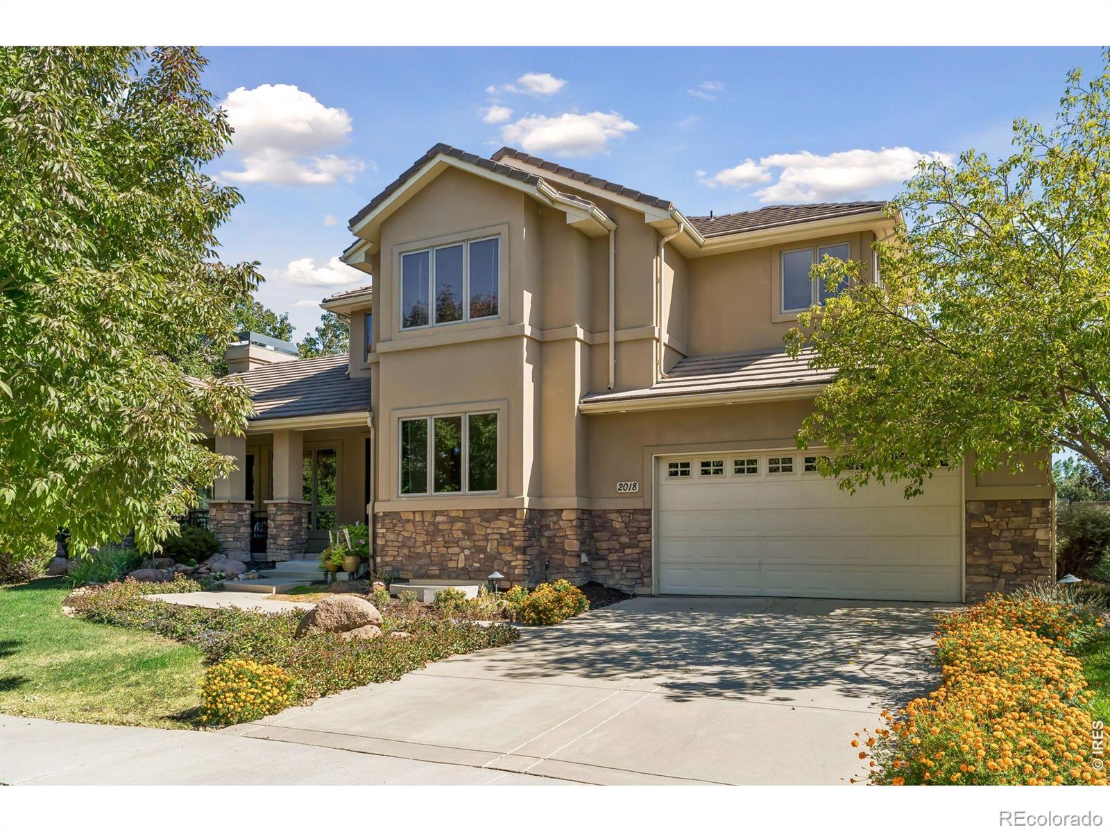 Set in sought-after Somerset Meadows in southwest Longmont, this exceptional custom home blends timeless craftsmanship, warmth, and livable luxury with a peaceful setting of mature trees, parks, ponds, open space, and beautiful mountain views. Inside, soaring ceilings, expansive windows, Brazilian walnut hardwood floors, hand-troweled plaster walls, and distinctive architectural details create an understated Old World-meets-Colorado character. At the heart of the home, the spacious kitchen features a substantial granite island, cherry cabinetry, copper sink, abundant storage, and a picture window overlooking the backyard pond and waterfall. The adjoining breakfast room opens directly outdoors, while gracious living and dining spaces make entertaining effortless. A private main-level study with an adjacent three-quarter bath offers flexibility for work or guests. Upstairs, four spacious bedrooms include a beautiful primary suite with views, a luxurious bath, and thoughtfully designed built-ins and closets. A secondary bedroom has an en suite bath, while two additional bedrooms share another generous bath. The finished lower level feels like a true extension of the home, with high-end finishes, a family room, wet bar, built-in surround sound, game space, an additional bedroom and bath, and abundant storage. Outside, a private backyard retreat features a pond and waterfall, stone walls, patio, pergola, mature landscaping, and a fruit-bearing grapevine-an inviting setting for entertaining or simply enjoying a quiet Colorado evening. Beautifully crafted, wonderfully private, and designed for real life, this is a home equally suited to everyday living, gathering with friends, and celebrating life's milestones. A place for living, loving, and making memories that last.