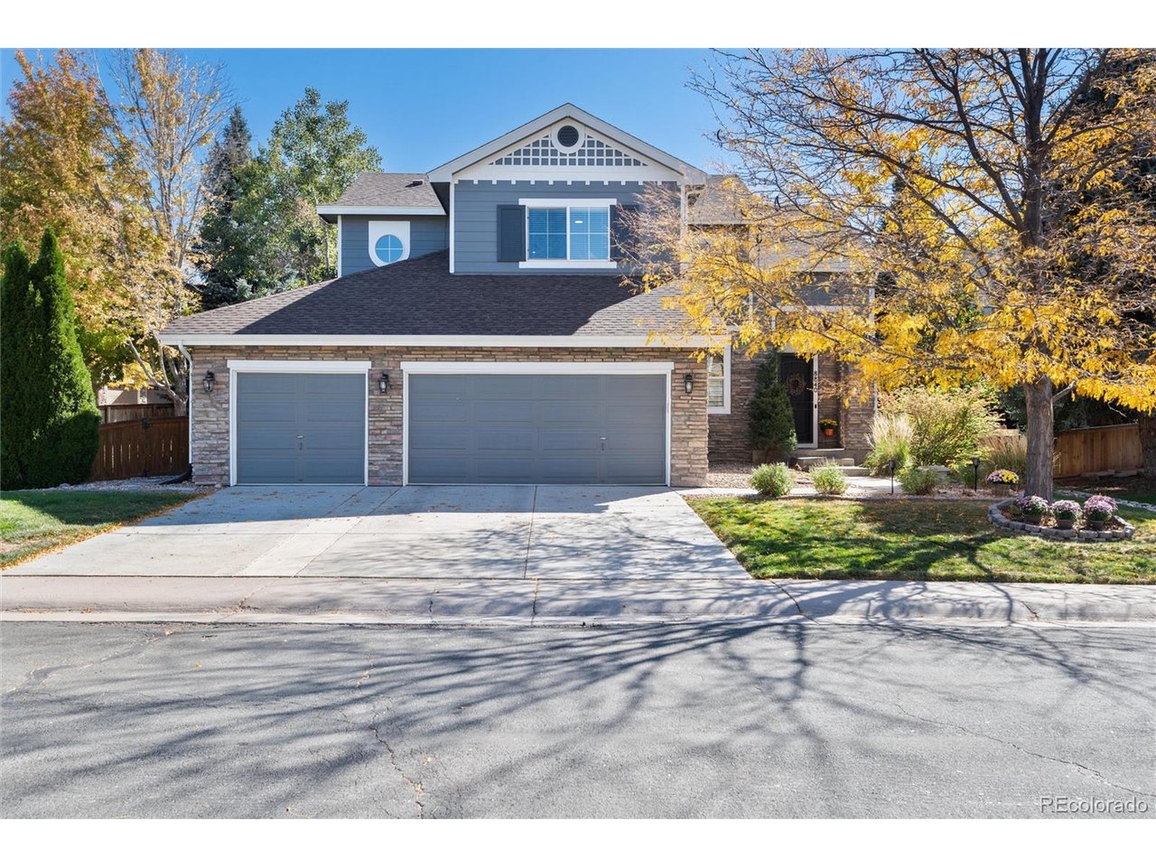Beautifully situated on an oversized corner lot in TrailMark, this distinctive home offers architectural character, flexible living spaces and a private backyard. Enjoy sunny northwest frontage, a three-car garage and greenbelt access just steps away, connecting to open space and miles of trails. A dramatic two-story living room features expansive windows and a striking fireplace. The main-floor flex room can serve as a formal dining room or study, while the family room offers a second fireplace, entertainment nook and backyard views. Designed for those who love to cook and entertain, the kitchen offers an abundance of granite counter space, a center island, stainless appliances, gas range, striking hammered copper sink and butler's pantry - with a sunlit dining area opening to the patio. Upstairs, the primary suite showcases a vaulted ceiling and arched transom window, plus a five-piece bath and 7' x 8' walk-in closet. Two additional upper-level bedrooms are complemented by a full bath featuring dual sinks and a separate shower area for added convenience. A bright and spacious loft offers an easy opportunity to create a fourth upper-level bedroom. The finished basement brings industrial character with exposed ductwork, metal ceiling details and contemporary finishes. Two flexible areas suit a guest retreat, bedroom, gym or recreation, while the unusually large half bath has room for a shower without sacrificing storage. The oversized backyard offers exceptional year-round privacy around the included hot tub. Along the hogback across from Chatfield Reservoir, TrailMark is surrounded by open space and threaded with scenic trails and two beautiful parks including a newly remodeled playground, seasonally stocked fishing pond, basketball courts, soccer fields, sledding hills and covered picnic areas. The exceptional HOA hosts year-round activities including concerts, food trucks, Easter egg hunt, 4th of July parade, outdoor movie night, chili cook-off and Santa visits.