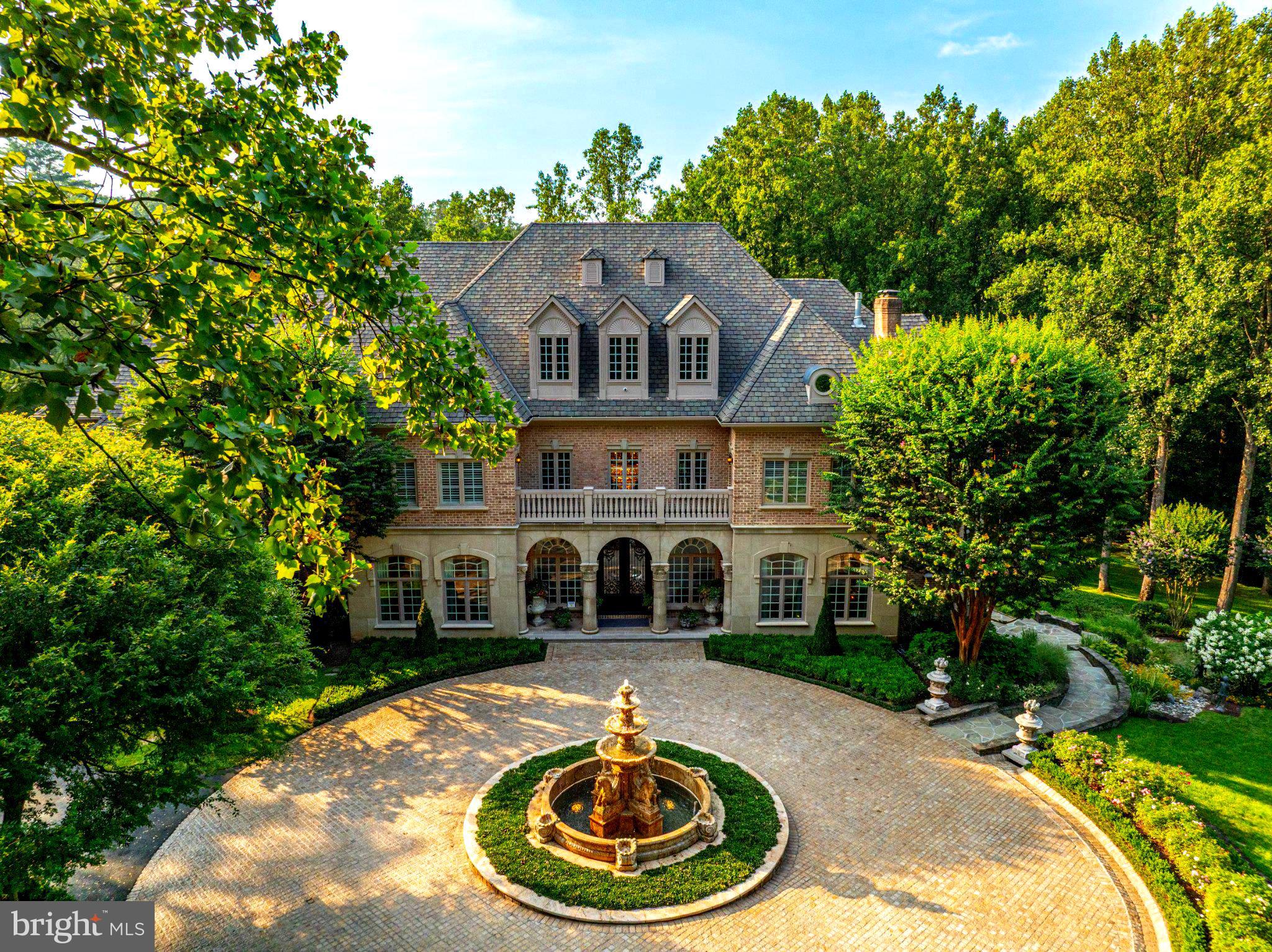 Nestled in the blissful hills surrounding Great Falls Park is a masterpiece of old-world craftsmanship and modern appointments, a unique combination of privacy and accessibility. Passing through the stately front gates is a breathtaking tree canopied sweeping driveway which culminates at the main residence with its commanding paver circular motor court and majestic fountain. The spectacular grounds feature lush specimen plantings, stunning hardscape, antique sculptures, Haddonstone garden gazebo, fountains, thousands of bulbs and so much more! The handsome facade showcases lovely arches and ornate precast columns. Step into the breathtaking foyer where your greeted by stunning Swarovski crystal chandeliers in every room, with gleaming marble floors and soaring ceilings setting a tone of timeless grandeur. Stunning plaster moldings with gold appointments and bespoke millwork flow from the foyer seamlessly into the living, dining and great room creating an elegant continuity throughout. The formal living room-bathed in natural light from Palladian windows overlooking the lush grounds exudes warmth and sophistication. French doors open to the music room and conservatory/sunroom, ensuring effortless flow for both grand entertaining and intimate gatherings. The library features lovely hardwood floors with inlay cherry borders, custom built-in cabinetry and custom shutters. A spectacular gourmet kitchen- well-appointed with crystal chandeliers, Viking range, Sub Zero and extra-large kitchen islands with intricate millwork, custom cabinets and countertops, wine/beverage refrigerators, specialty tile backsplash, generous breakfast room with fireplace and floor to ceiling windows and French doors opening to the terrace, brick patio to enjoy morning coffee! Upper level has 5 bedrooms with en-suite full baths. Gleaming hardwood floors, large windows with shutters and backstair case.Primary Suite - is a sanctuary of refinement featuring 23 carat gold leaf ceilings, angled hardwood floors, tray ceilings and a sitting room warmed by a glass-enclosed fireplace all overlooking the stunning grounds. Crystal sconces and detailed plaster moldings accentuate soaring ceilings, blending grandeur with intimacy. Primary Bath- spa-inspired retreat with 20 “marble floors, marble vanities adorned with Mother-of-Pearl inlays and intricate gold inlays and imported Italian tile with custom solid brass fixtures. Indulge in a spa shower with body sprays or unwind in the tub - an indulgent oasis of relaxationThe walk-out lower level crafted for unforgettable gatherings features a billiards area with custom sconces and recessed lighting, a top-of-the-line golf simulator, fireplaces and a state-of-the-art theater with paneled walls and a home gym/work out room. A full kitchen with granite counters and large breakfast bar ensures seamless hosting. A spacious recreation room with expansive windows and a playroom/bedroom with full baths offer versatility. Extra-large 4 car garage. Fenced compound, luscious gardens, terraces, deck, fountains. granite block paver motor court, generators, state-of-the-art security, irrigation system complete this amazing offering. Equestrian in the family? Many facilities in the area! (See map in documents) All within 25 minutes of Dulles & Reagan National airports - Langley High School Pyramid-Registration form needs to be provided with showing request. Thank you!
