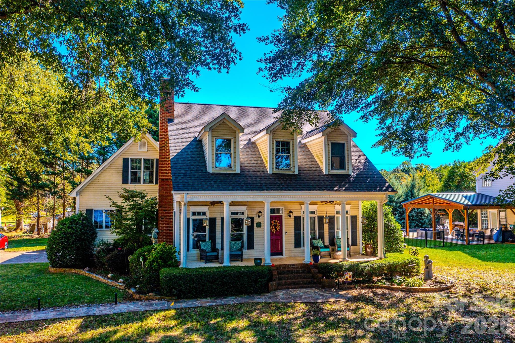 Gorgeous southern charm home overlooking Lake Norman is perfectly nestled between Huntersville and Denver for ultimate convenience! Whether you love to cook in this custom kitchen or love to entertain in the bonus room, this home has everything you could wish for: high ceilings, 2 spacious kitchen islands, custom appliances, relaxing/soaking tub with privacy tinted window, beautiful landscaping including stone walkway and borders around trees and flowerbeds, landscape lighting, water fountain feature,  covered rocking chair front porch, huge 2 car garage with tall ceilings and shelving, walk-in closets in all bedrooms, walk-in attic for storage, tankless hot water heater, views of Lake Norman from several windows and drypro maintained crawlspace with French drain and sump pump.  There is just too much to list it all. Homes in this neighborhood hardly ever come available. Do not miss this opportunity to enjoy lake life without the waterfront price tag!  For more information contact Beth Noles 704 564 2447 bethnoles@bluebikerealty.com