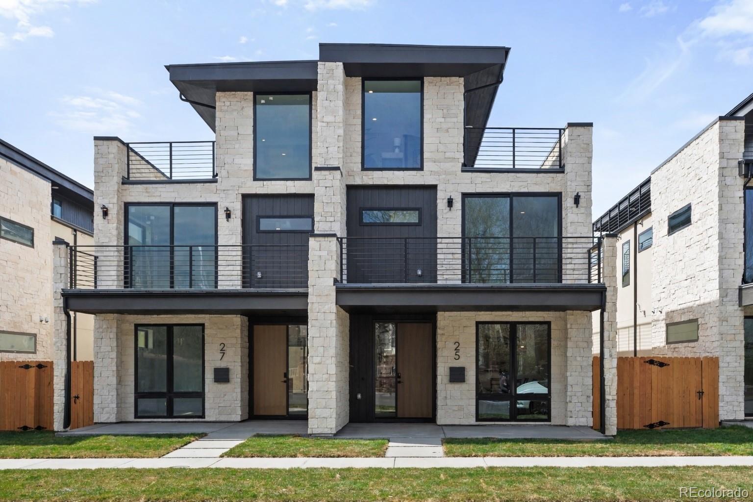 A statement in modern design, this architecturally curated Cherry Creek duplex reflects PBG’s uncompromising attention to detail and craftsmanship. Less than a 10 minute walk from the neighborhood’s premier dining/boutiques, the 5-bed, 5-bath residence blends organic textures with elevated, contemporary interiors. Natural stone and warm wood accents are framed by clean architectural lines, forming a timeless, design-forward exterior. Inside, wide-plank engineered white oak flooring and expansive glazing invite abundant natural light, defining the home’s bright interior. The living room is anchored by a sculptural fireplace framed by refined wall detailing, creating a clean and sophisticated focal point. Designed as the heart of the home, the chef’s kitchen showcases custom two-tone cabinetry in satin white oak and soft white, accented by brushed nickel hardware, integrated Thermador appliances, and a statement waterfall island clad in Matarazzo leathered stone. Upstairs, the primary suite features a private balcony, gas fireplace, and wet bar, complemented by a spa-caliber bath finished in Matarazzo leathered stone and blonde ash KRO cabinetry. The bathroom showcases accent tile, dual wall-mounted champagne bronze faucets, a freestanding soaking tub, a glass-enclosed dual-head shower, and heated floors. A secondary en-suite bedroom and spacious laundry room complete this level. The rooftop level offers a bedroom and office, ¾ bath, wet bar, and expansive deck with city views and mountain views. The finished basement with soaring 10-foot ceilings expands the home with a recreation area, wet bar, full bath, additional bedroom, and optional fitness room. A private backyard with covered patio, gas hookup, and TV prewire extends the indoor/outdoor lifestyle. Detached two-car garage includes 220V capability and optional overhead storage. PBG industry leading 2-year builder’s warranty/8-year structural warranty. Prewired for speakers | No HOA | |Buyer to Verify All Details