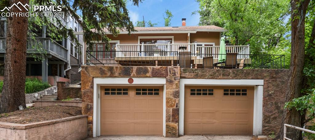 Charming Creekside Retreat Near Manitou Incline — Scenic Views, Modern Upgrades, and Exceptional Outdoor Living

Discover your dream home in this beautifully maintained 1914 Mission-style retreat, perfectly situated just steps from the famous Manitou Incline, popular trails, and charming downtown Manitou Springs. Ideally located for those who love outdoor adventure, this home seamlessly combines character, comfort, and modern conveniences — all in a highly desirable neighborhood.

Step inside and appreciate the home’s rich character, from its 9-foot ceilings and custom wood blinds to its beautiful hardwood floors and thoughtfully updated finishes. The updated kitchen shines with stainless steel appliances and granite counter tops, perfect for entertaining and daily living alike.

Relax in your expansive 28x13 primary bedroom with an en suite full bathroom, complete with a walk-out deck surrounded by trees. Outdoor spaces abound — from a back patio on the upper level with quick access from the master suite and wired for a hot tub, a vegetable garden, a second deck at the front of the home with stunning views of Red Mountain and Engleman Canyon and a peaceful creek running through the property — perfect for unwinding or entertaining.

Additional highlights include brand new exterior paint, freshly painted interior, a 2-car garage with additional off-street parking — a rare find in Manitou! A newer grade 4 roof, new furnace in 2020, a replaced sewer line with exterior clean-outs, and a bonus lot for added privacy or future possibilities.

Whether you’re looking for a primary home, a vacation getaway, or a strong investment opportunity, this charming retreat offers a perfect blend of historic character, modern upgrades, and unbeatable location — just minutes from trailheads, restaurants, and all the best Manitou Springs has to offer!