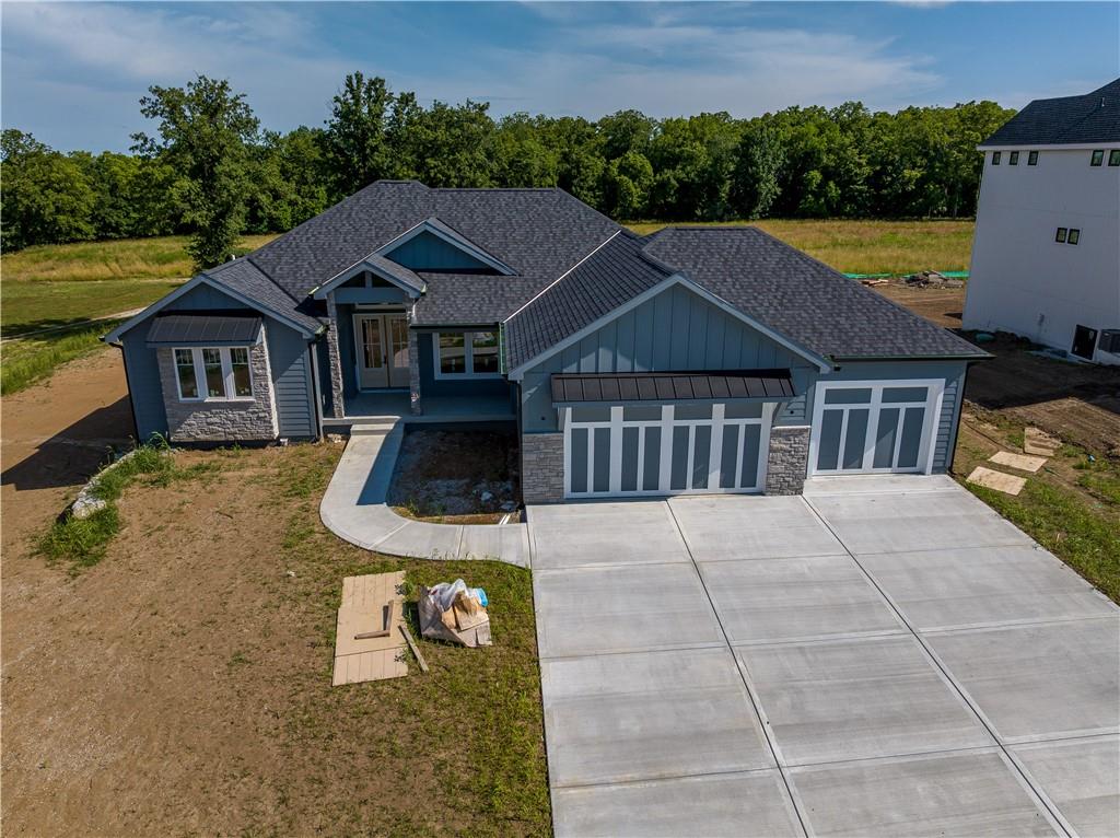 Welcome to your dream home! This stunning 4 bedroom, 4 bathroom reverse custom-built home offers 3,638 SF of luxurious living space and incredible features throughout. Located on a second tier lot with beautiful lake views, this home includes a designated boat slip, just a short walk away, giving you easy access to boating, fishing, and lakeside fun.

Enjoy main level living with two spacious bedrooms on the main, and two additional bedrooms on the lower level, perfect for family or guests. The massive master closet is an absolute dream come true! The covered deck with fireplace overlooks HOA greenspace and a walking trail, creating a peaceful, private retreat right out your back door. The home is also bordered by greenspace on two sides for added privacy and tranquility.

At the heart of the home is a chef’s kitchen, complete with high-end appliances, custom cabinetry, a spacious island, and a butler’s pantry, ideal for hosting and everyday luxury. A large bonus room with glass doors offers flexible space to customize as a home gym, office, playroom, or whatever suits your lifestyle.

Additional features include a 3-car garage with a 4th garage door that opens to the backyard, perfect for outdoor entertaining or convenient access. You'll also enjoy access to a community loaded with amenities: tennis and basketball courts, horse stables, and a brand-new community pool coming soon.