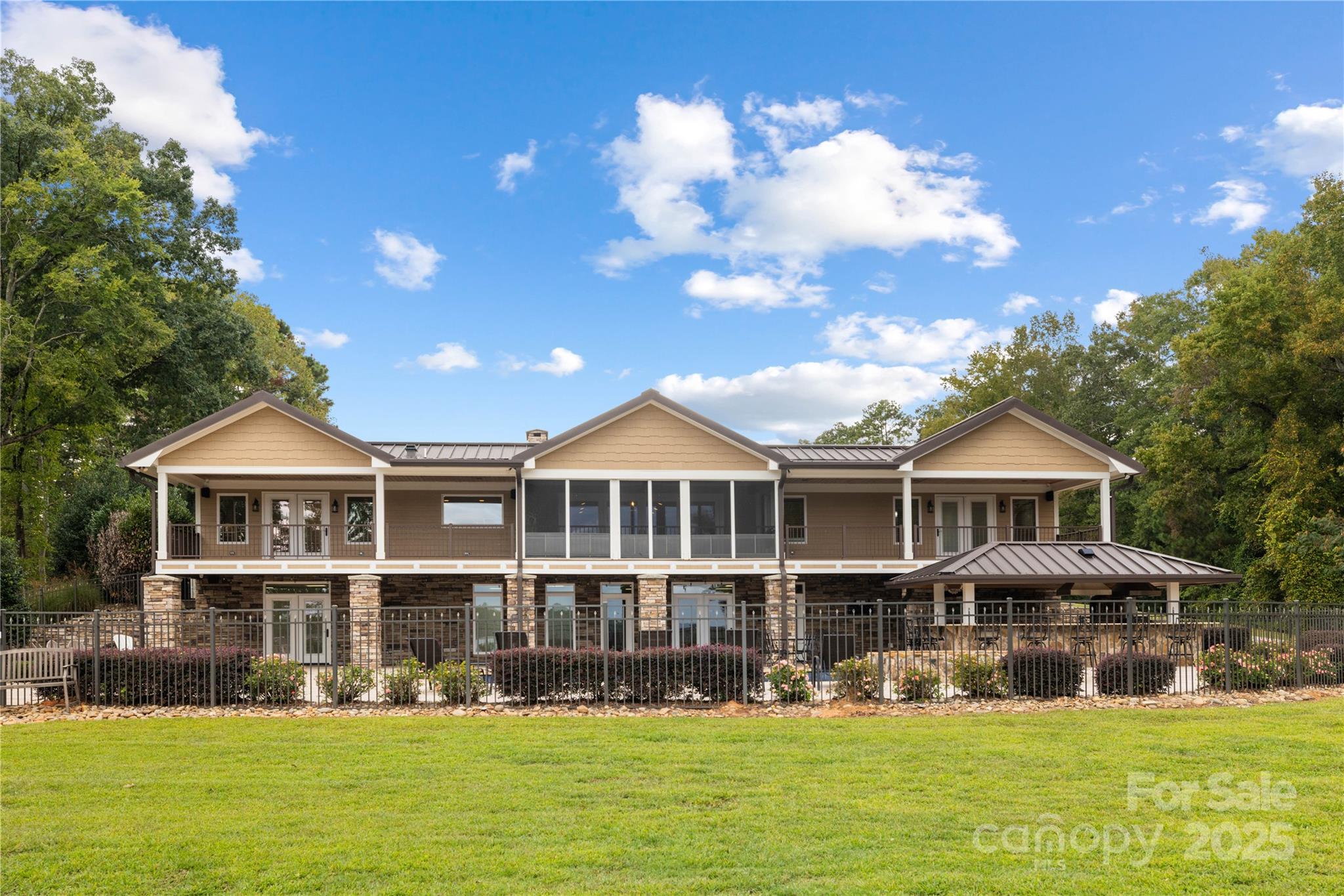 Nestled across from a golf course and sitting on nearly 13 acres, this breathtaking 5-bedroom, 6.5-bathroom home offers the perfect blend of luxury living and outdoor recreation. With 500 feet of prime lake frontage on Lake Tillery, a stocked pond, and private sports courts, this property is an entertainer’s dream.

Home Features:

Spacious Layout: Offering over 6,000 sq. ft. of living space, this home includes 5 bedrooms and 6.5 bathrooms. The expansive primary suite is conveniently located on the main floor for ultimate privacy and easy access to the outdoor amenities.

Two Full Kitchens: The home features two fully-equipped kitchens—one on the main floor and another in the basement—perfect for entertaining or creating a separate living area for family or guests.

Lakefront Access & Dock: Enjoy 500 feet of stunning lake frontage on Lake Tillery, complete with a private dock for 2 boats and 4 jet skis. The entertainment dock, featuring a diving board and fish feeder, is perfect for unwinding or fishing—Sellers have even caught a 34-lb catfish right from the pier!

Private Sports Courts: Whether you're into tennis, basketball, pickleball, or baseball, this property has it all. Enjoy your own private courts, along with a professional-grade batting cage for baseball fans.

Resort-Style Pool and Spa: The backyard oasis includes a heated pool and hot tub that spills into the pool, offering year-round enjoyment. An outdoor kitchen completes the space, making it perfect for outdoor cooking and entertaining.

Finished Basement Retreat: The fully finished basement offers 2 additional bedrooms, a second kitchen, a spacious living area, and a cozy game room with a fireplace—ideal for guests, family, or a private retreat.

Extra Amenities: A fully equipped gym and a drive-through garage provide added convenience, while the expansive 12.87-acre property offers ample space for privacy and recreation.

Additional Highlights:

Privacy & Space: With 12.87 acres of land, you’ll enjoy the freedom to roam, plus plenty of space for outdoor activities, all while being surrounded by nature.

Prime Location: Though it feels like a secluded getaway, the estate is just across from a golf course and conveniently located near shopping, dining, and other local amenities.

This property has everything you need—luxury, comfort, and endless opportunities for recreation, relaxation, and entertaining. Don’t miss your chance to own this one-of-a-kind estate!

Professional Photos will be updated by 10/9/2025