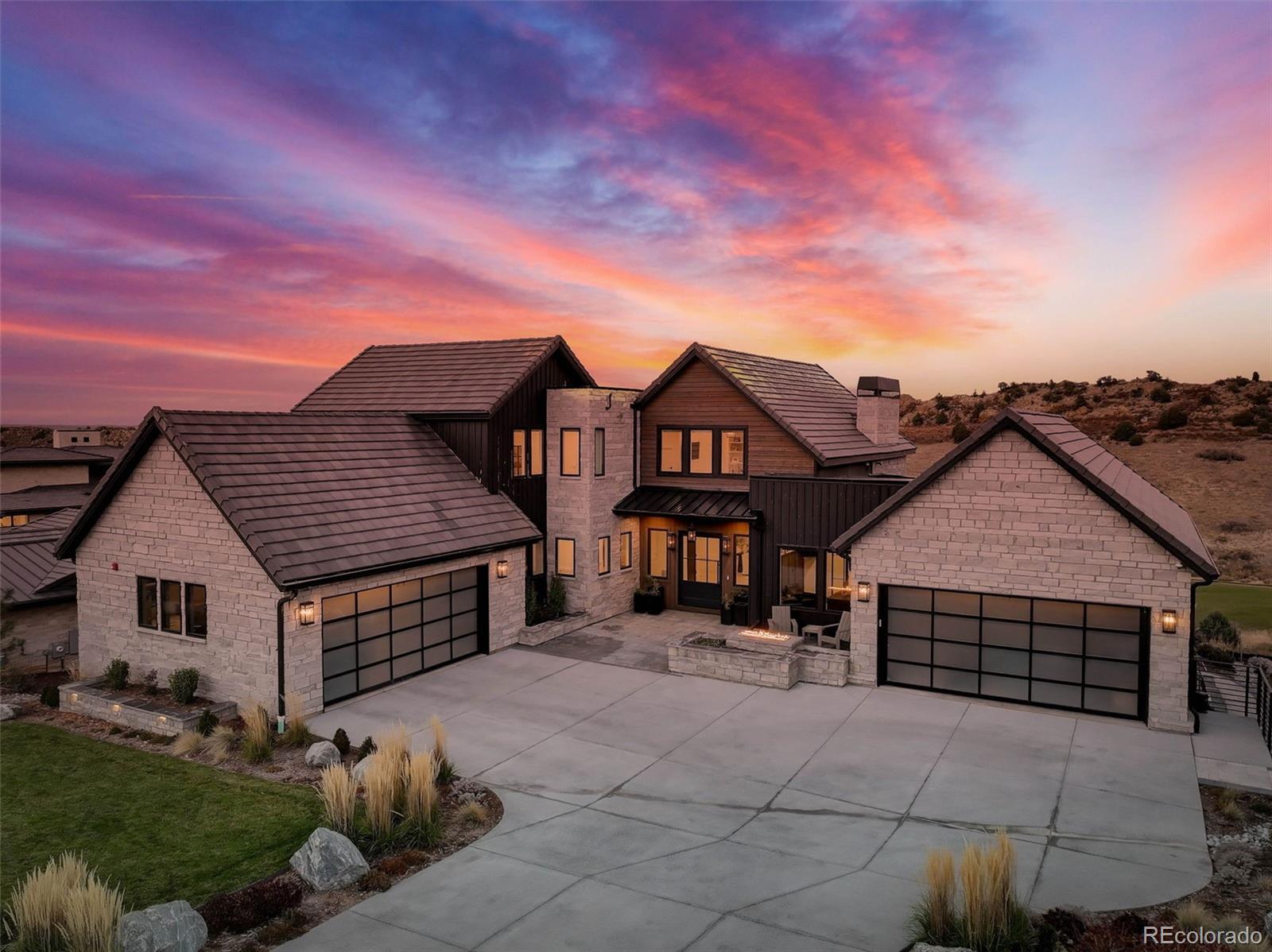 Welcome Home—Where Luxury and Resort-Style Living Meet! Perfectly situated off the 15th T-box, this exquisite property offers breathtaking views of the prestigious Jay Moorish–designed golf course and the iconic Hogback ridge, all within the highly sought-after Ravenna community. Nearly new and thoughtfully designed, this 7,294-square-foot home features five bedrooms and seven bathrooms, blending sophistication, comfort, and modern functionality in every detail.

The chef’s kitchen impresses with a $7,000 custom hood, quartzite countertops, Wolf and Sub-Zero appliances, dual dishwashers, a steam oven, under-counter ice maker, and reverse osmosis water at the bar. The great room showcases soaring ceilings, a refined fireplace, and accordion doors that open to awe-inspiring mountain views—creating the ultimate indoor-outdoor living experience.
The main-floor primary suite offers a private deck for sunrise views, a spa-inspired five-piece bath with marble tile, Robern medicine cabinets, and a custom California Closets walk-in. A conveniently located laundry room, a private guest suite with full bath and an executive office complete the main level.

Downstairs, the sunlit lower level is both expansive and expertly designed, featuring a bar with dishwasher and beverage refrigerator, wine cellar, game area, exercise room with golf simulator, meditation room, powder room, and a second laundry. Two spacious bedrooms with ensuite baths and custom California Closets complete the space.

The outdoor oasis epitomizes resort-style living with a saltwater, temperature-controlled pool featuring a fountain and in-water bar stools, a 92” hot tub, an inviting fire pit lounge, and a built-in grill with dining area—perfect for entertaining or relaxing in style.
Come experience the Ravenna lifestyle—where elegance, leisure, and luxury converge.