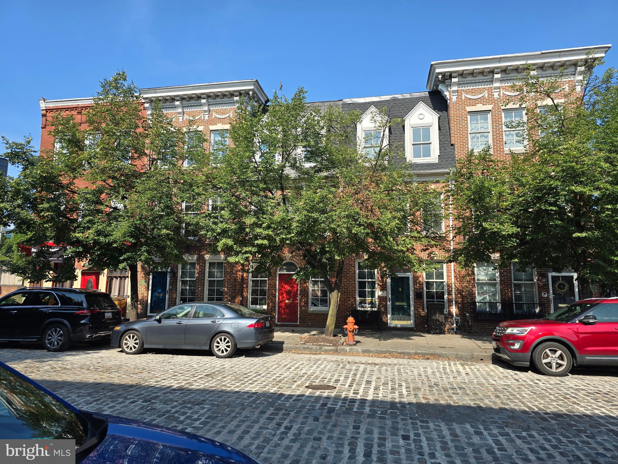 Far from ordinary, this  exceptional , recently built, Federal style townhouse is situated in the heart 0f the Fells Point Historic District. The Fell family would have been more than proud to call this their home if it were available in their time period.  This townhouse is updated to the standards of the 21 century. It includes all the ambiance of the Colonial Era, yet features all space and  benefits of today.  Two primary bedrooms with their own bathrooms, an open concept living area with tall ceilings, 2 strategically located balconies and a spacious rooftop deck. The floors in the upper levels are hardwood oak.  The open living area is graced with a gas log fireplace.  A one car attached garage is included, so unlike yesteryear you no longer need to house the horse and carriage in the Livery Stable across the Street.   No smokers please. This house is situated in the Fells Point Historic District and located just a block or so from Baltimore's newest waterfront communities.  Harbor Point and Harbor East.