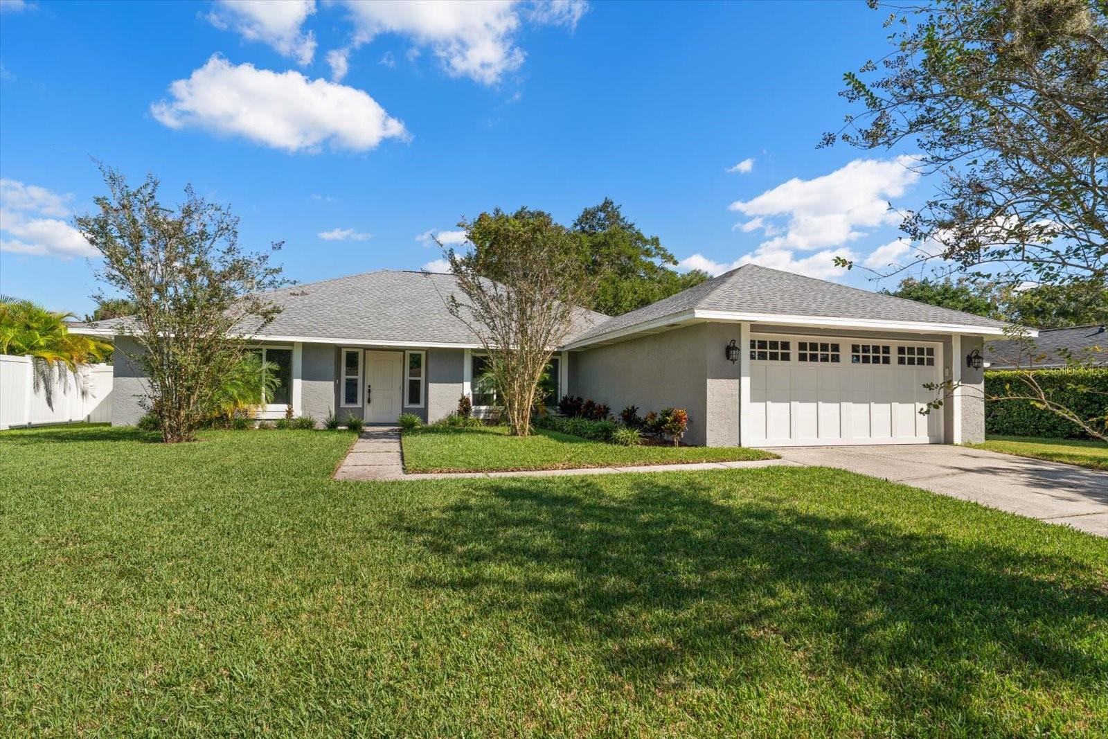 Virtually Staged. Welcome to this beautifully maintained home in the desirable Carrollwood Springs community, where a quiet, walkable neighborhood and convenient location create an ideal Tampa lifestyle. Great curb appeal, sidewalks, and streetlights welcome you into this inviting residence with an open, bright floor plan and durable LVP flooring throughout. The spacious family room and dining room combination is designed for comfortable everyday living and effortless entertaining, featuring a cozy fireplace, vaulted ceiling, and sliding doors that open to the patio and private, fenced backyard. The kitchen flows seamlessly into the living space and offers stainless steel appliances, a pantry, and a convenient adjoining laundry room. The split-bedroom layout provides privacy, with a spacious primary suite featuring two closets and a private bath with double-sink vanity and walk-in shower. Additional bedrooms are well-appointed and share a beautifully renovated bath with a tub/shower combination and double-sink vanity. Major updates include impact windows, a new AC unit, and a newer roof, providing added peace of mind. Enjoy the quiet community setting while being just minutes from Dale Mabry Highway, the Veterans Expressway, outstanding dining and shopping, Tampa International Airport, and downtown Tampa. This is a wonderful opportunity to enjoy comfort, convenience, and an established Carrollwood lifestyle in one inviting home.